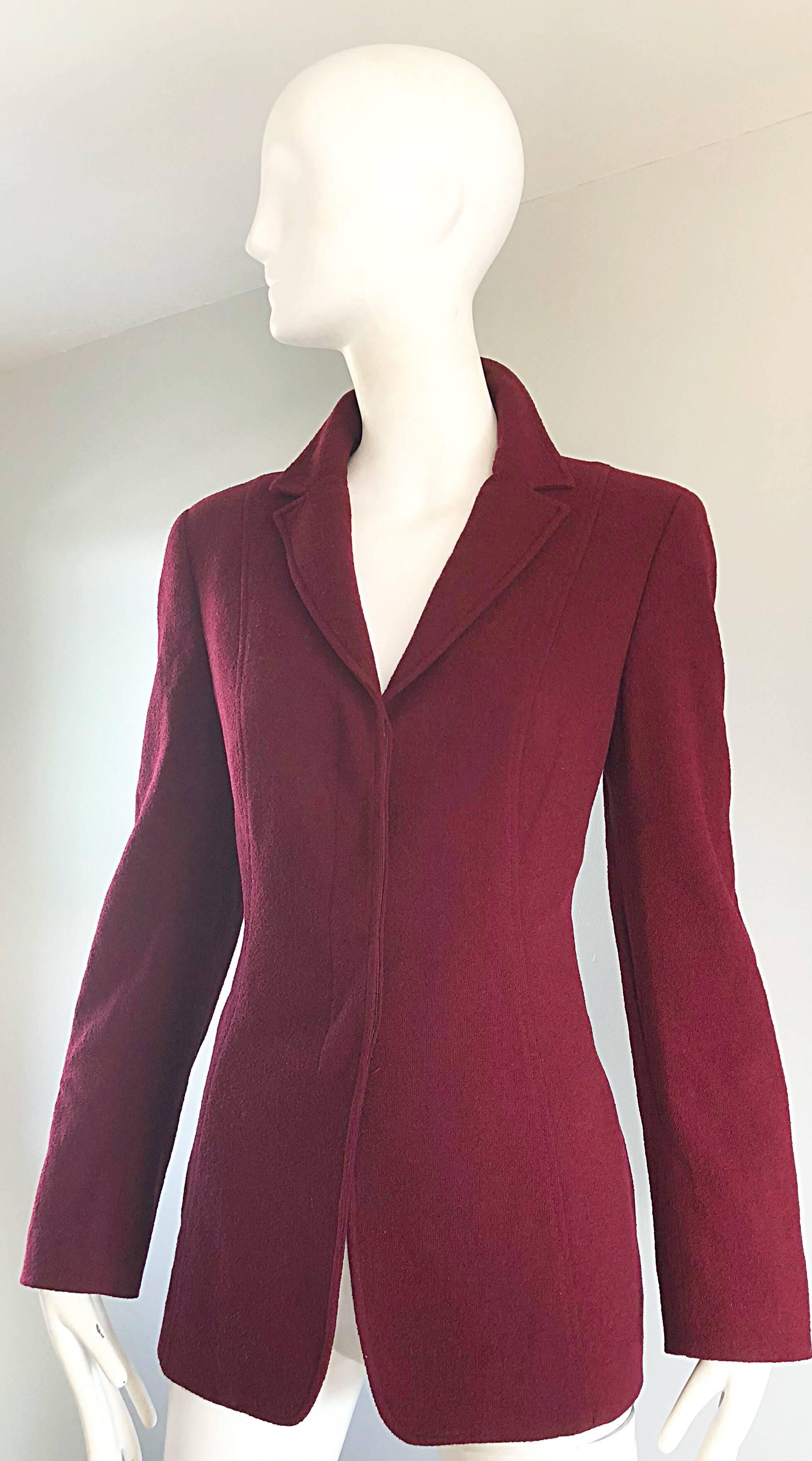 Chic 90s CALVIN KLEIN COLLECTION burgundy / maroon virgin wool blazer jacket! Features a smart tailored fit, with three hidden buttons down the front. Fully lined. Pockets at each side of the waist. Can easily be dressed up or down. Great with