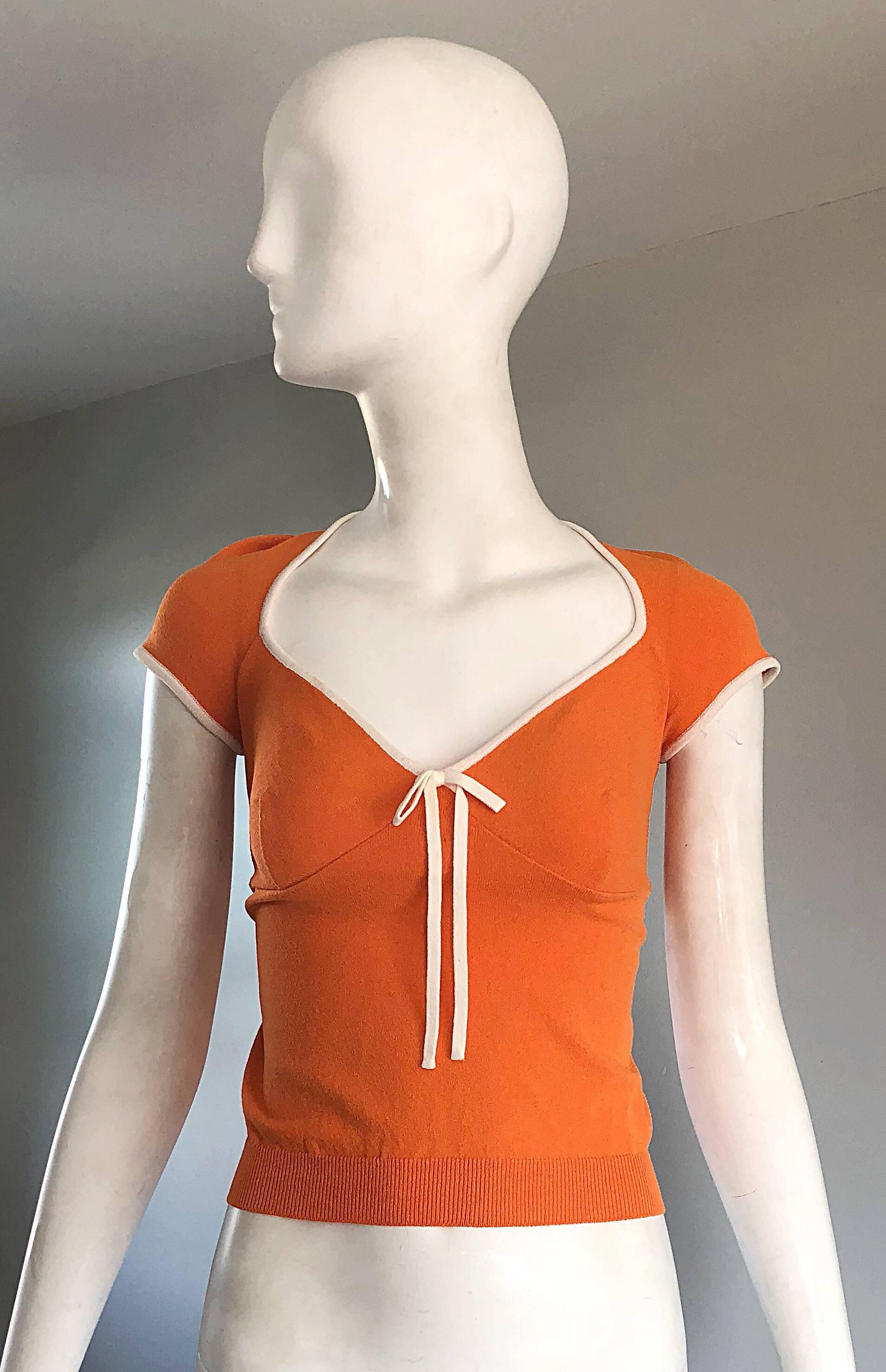 Adorable 1990s MOSCHINO CHEAP AND CHIC orange and white cap sleeve top! Soft crepe rayon stretches to fit. Chic bow at center bust. Vibrant orange color, with white trim along the neck and cap sleeves. Can easily be dressed up or down. Great with