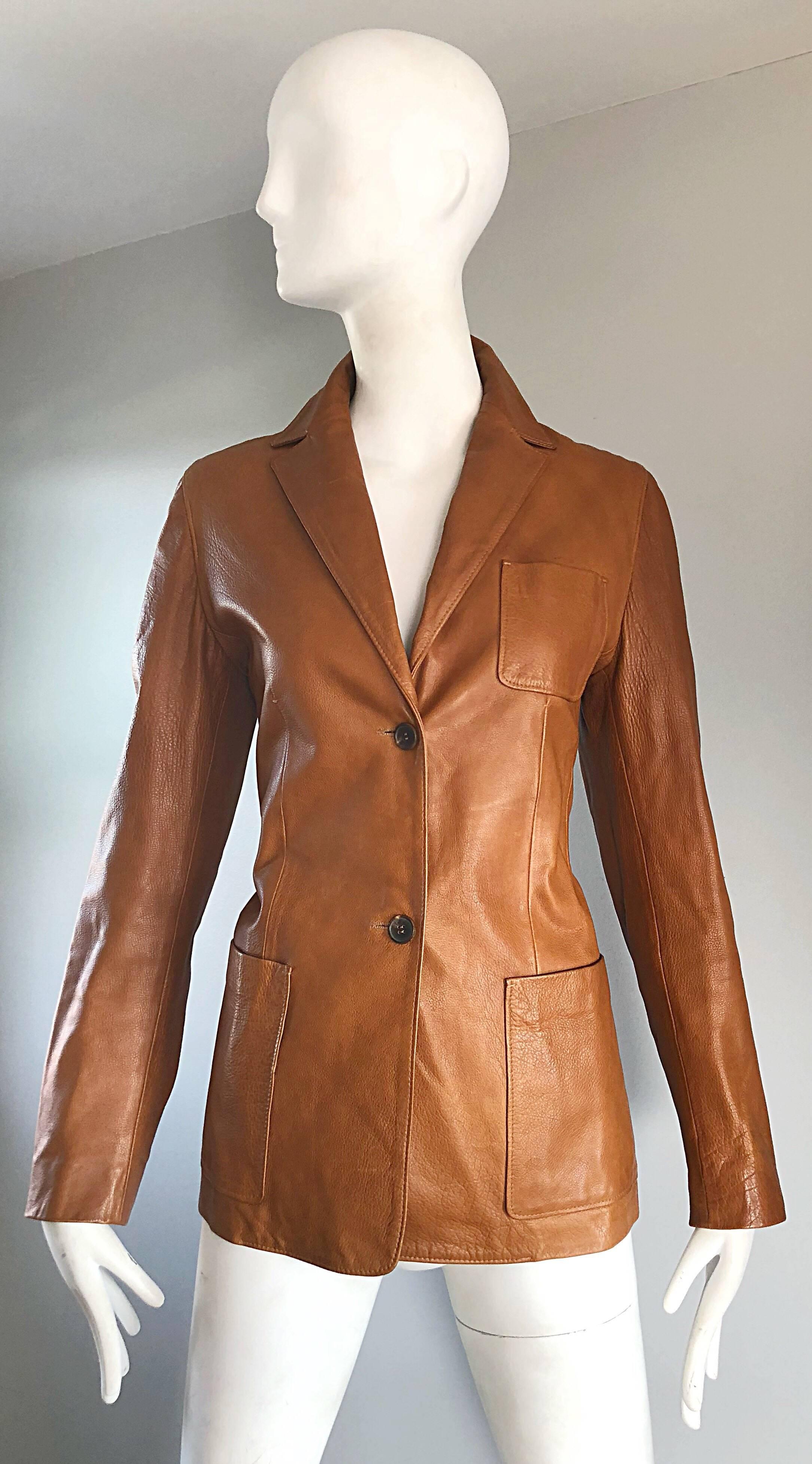 Classic, yet stylish 90s JIL SANDER camel / brown leather blazer jacket! Sharp tailored fit, with two buttons up the front. Pockets at each side of the waist, and at left breast. Fully lined. Looks fantastic on, buttoned or unbuttoned, with the