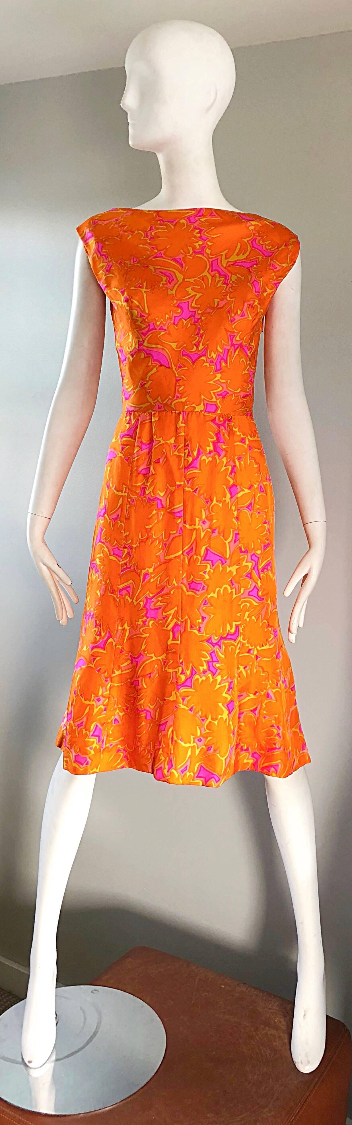 Beautiful vintage 1960s bright neon orange and hot pink printed silk A-Line dress! Features a flattering high boat neck, with a fabulous dipped draped back. Cap sleeves cover just the right amount of arms for year round. Fitted bodice, with a full