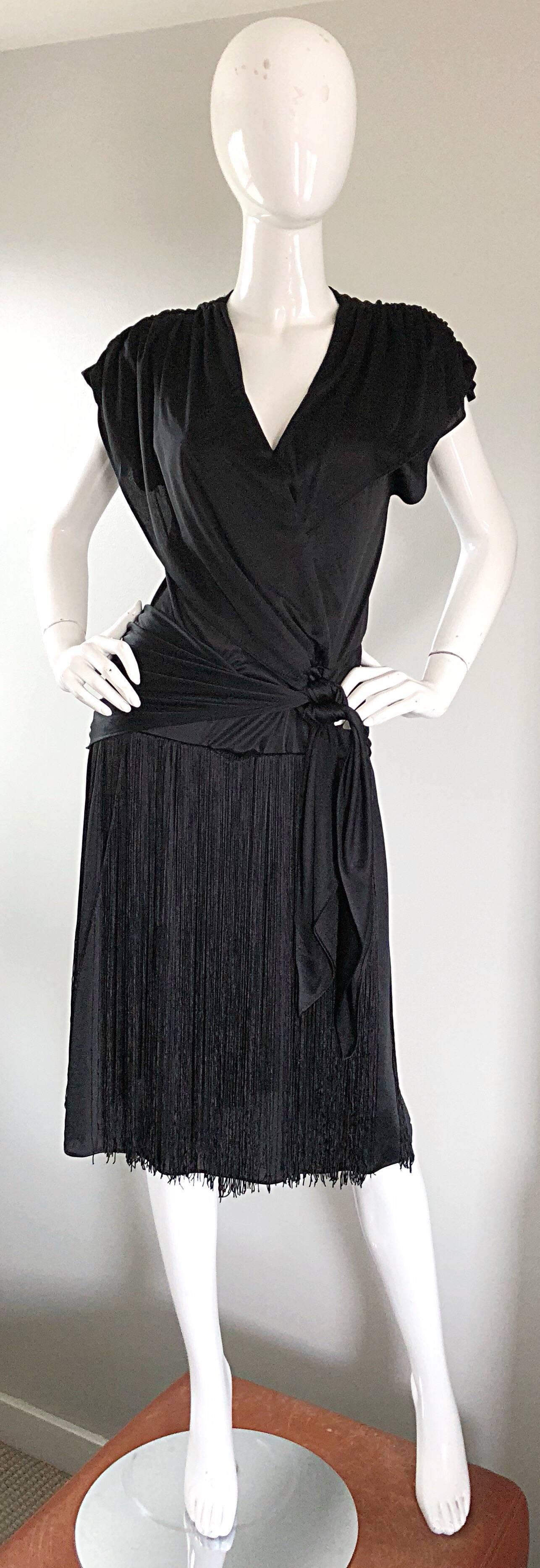 Amazing 70s does 20s flapper meets disco black jersey fringe dress! Features a blouson bodice, with a slightly dropped waist that ties at the side. Fully fringed skirt looks great with movement (especially on the dance floor). Excellently
