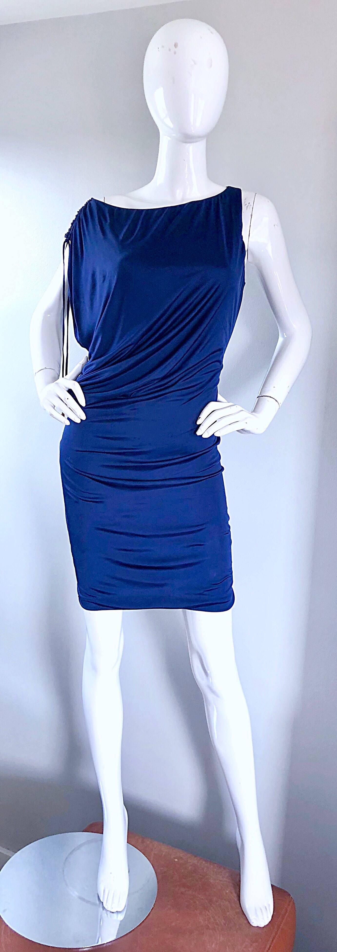 Sexy mid 1990s ROBERTO CAVALLI navy blue off-the-shoulder Grecian style silk jersey dress! Features a flattering stretch silk jersey, with gathers and drapes that stretch to fit. Beading and tie detail at top left shoulder (ties can be tied in a