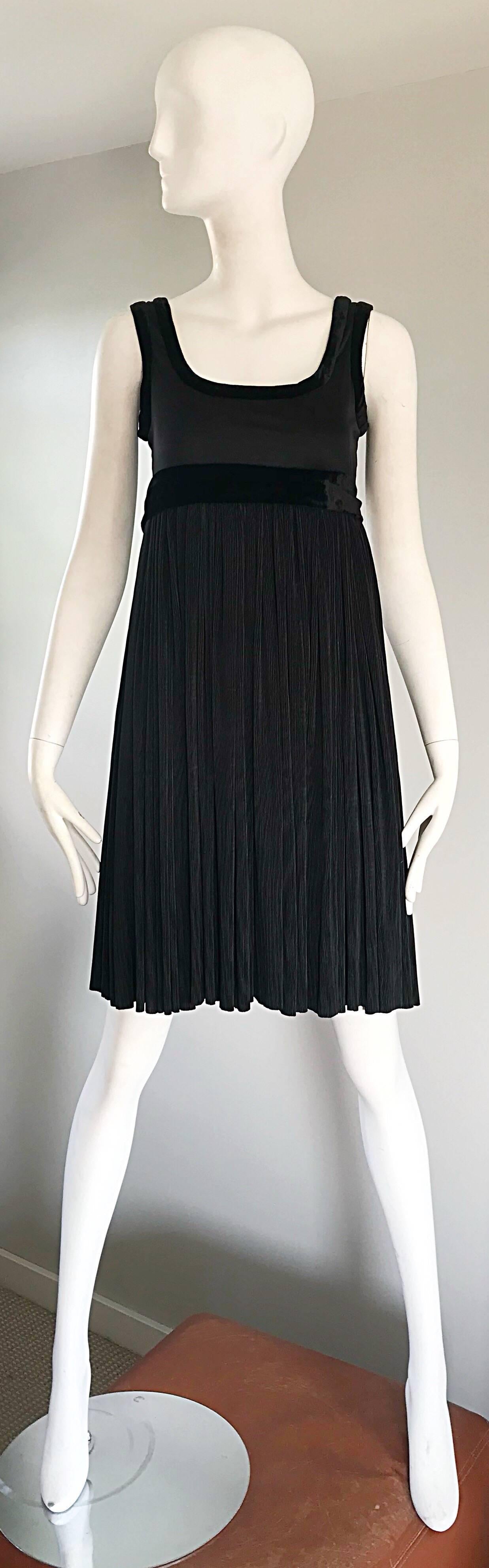 Talk about the perfect little black dress! This 1990s ROMEO GIGLI is the ultimate of LTBs! Features a fitted bodice, with Avant Garde silk velvet trim around the neck, sleeves and waist. Forgiving and flattering accordian pleated skirt will fit a