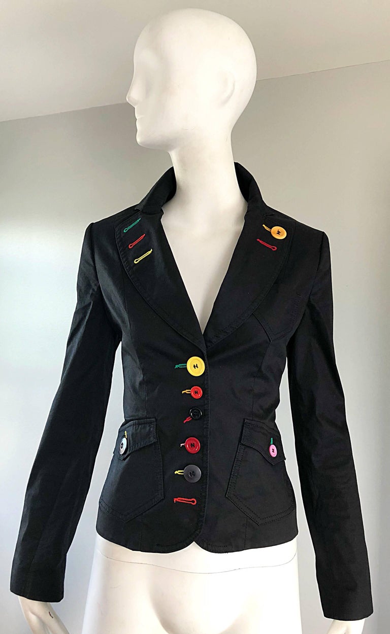 Chic vintage MOSCHINO rainbow buttons black blazer jacket! Features buttons up the front, at side pockets, sleeve cuffs, and lapel. Vibrant colors of yellow, red, pink, purple, black and green throughout. Pockets at each side of the waist. Sharp