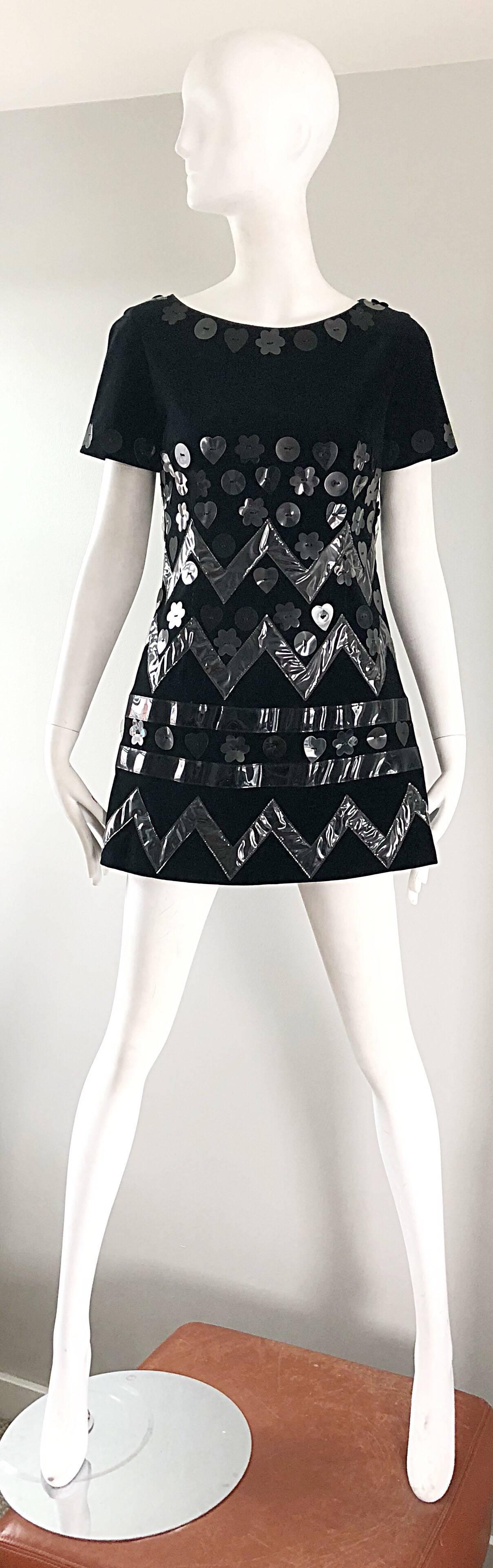 Incredible iconic 1990s does 1960s MOSCHINO Cheap and Chic black velvet and clear and black vinyl mini shift dress! Features hundreds of clear and black plastic pailette sequins in hearts, flowers and zig zags throughout. Wonderful tailored fit!
