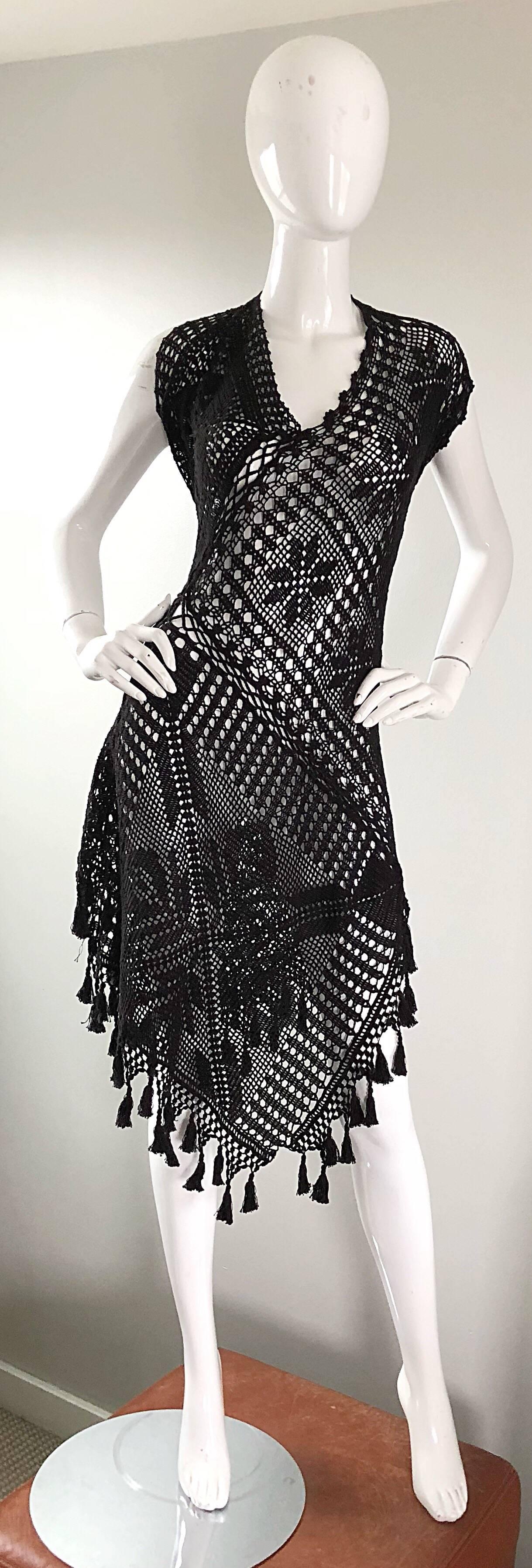 Rare and iconic 90s JEAN PAUL GAULTIER black hand crochet poncho tunic halter dress! Features asymmetrical hand-sewn crochet, with handkerchief hem, and attached fringe pom-poms at hem. Can be worn multiple ways--covering the shoulders, bunched up
