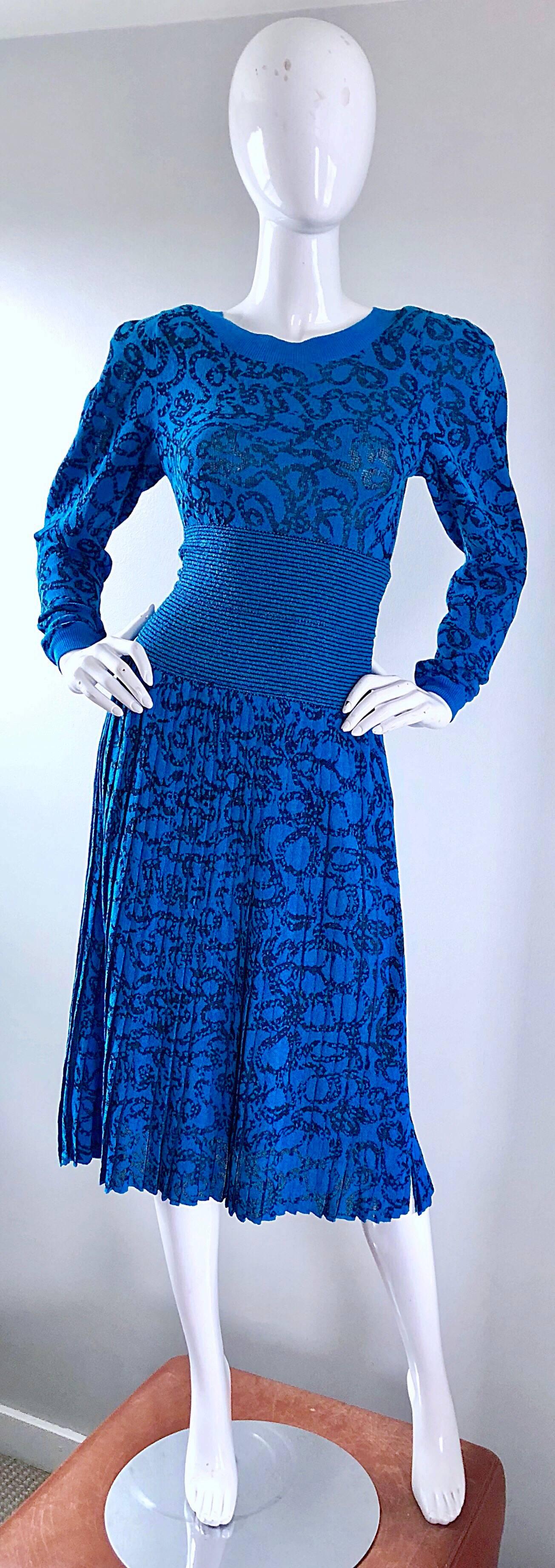 Stylish 80s vintage MISSONI for NEIMAN MARCUS knit sweater and pleated skirt dress set! Features a deep turquoise blue backdrop, with a black chainlink / ribbon print throughout. Fitted sweater features exaggerated shoulder pads, with a tailored