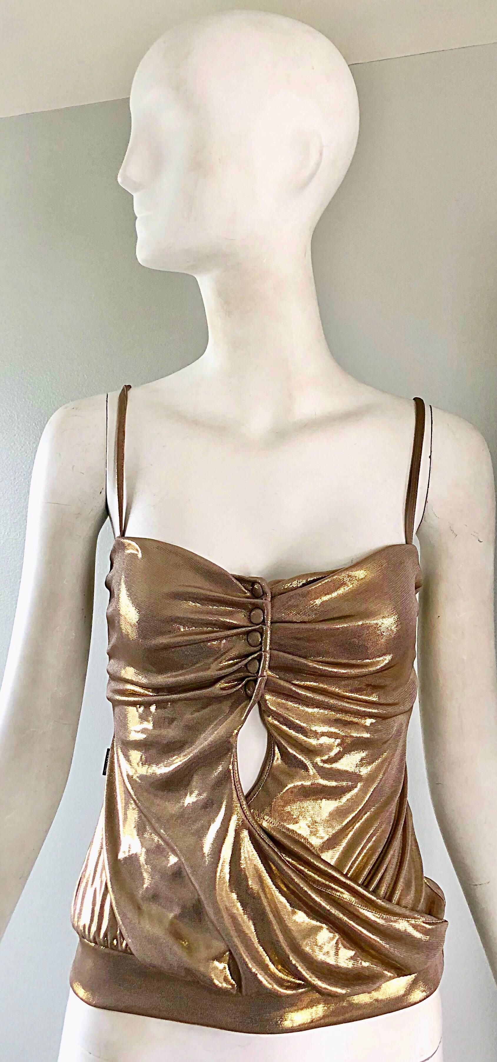 Sexy 1990s MOSCHINO gold cut-out spaghetti strap top! Features slinky gold metallic lame jersey. Mock buttons at top center bust, with cut-out detail below the bust. Elastic waistband stretches to fit. Very flattering top, that reveals just the