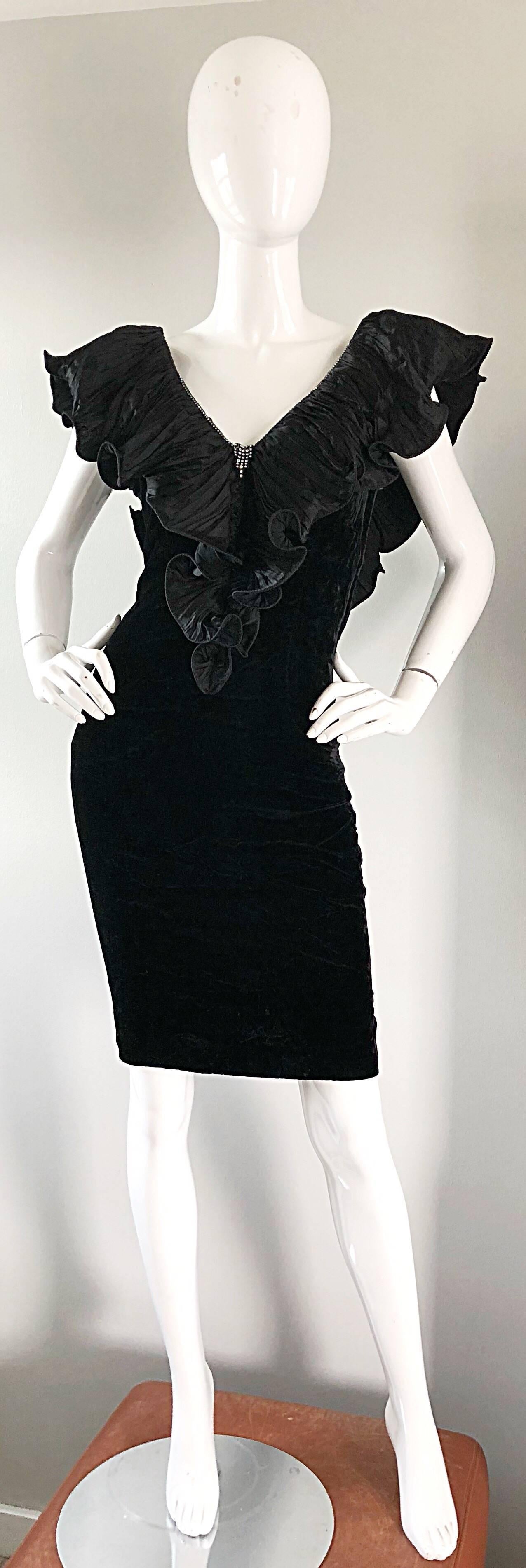 Extraordinary mid 1980s vintage black crushed velvet bodcon dress! Features a soft crushed velvet, with a taffeta pleated ruffle collar and back. Rhinestone detail along the front and back collar. Hidden metal zipper up the side with hook-and-eye