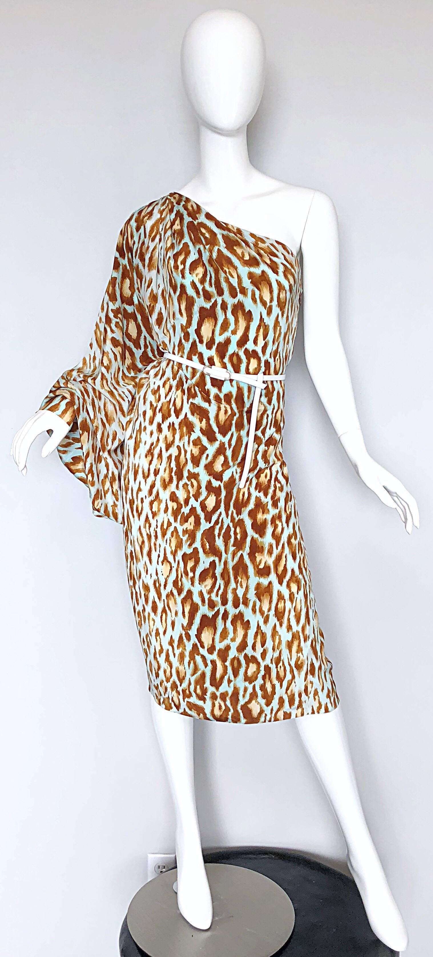 Amazing JOHN GALLIANO for CHRISTIAN DIOR cheetah print one shoulder silk dress! Features a light blue, brown and tan leopard animal print throughout. White leather belt loops through the front and back. Hidden zipper up the side with 
Hook-and-eye