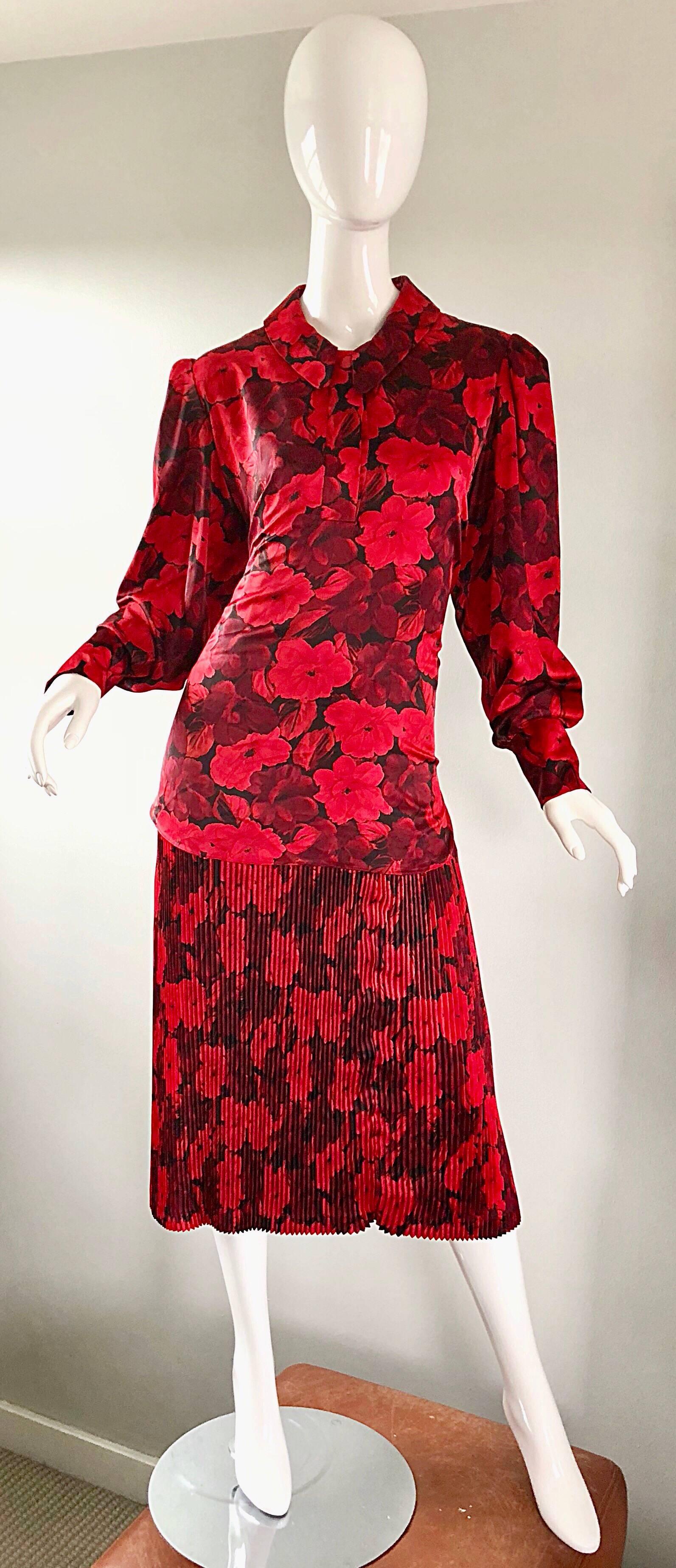 Beautiful vintage NINA RICCI 1980s red and black flower printed drop waist 1920s style flapper inspired dress! Features red and black floral print throughout. Hidden buttons up the front neck, and at each sleeve cuff. Accordian fortuny  pleated