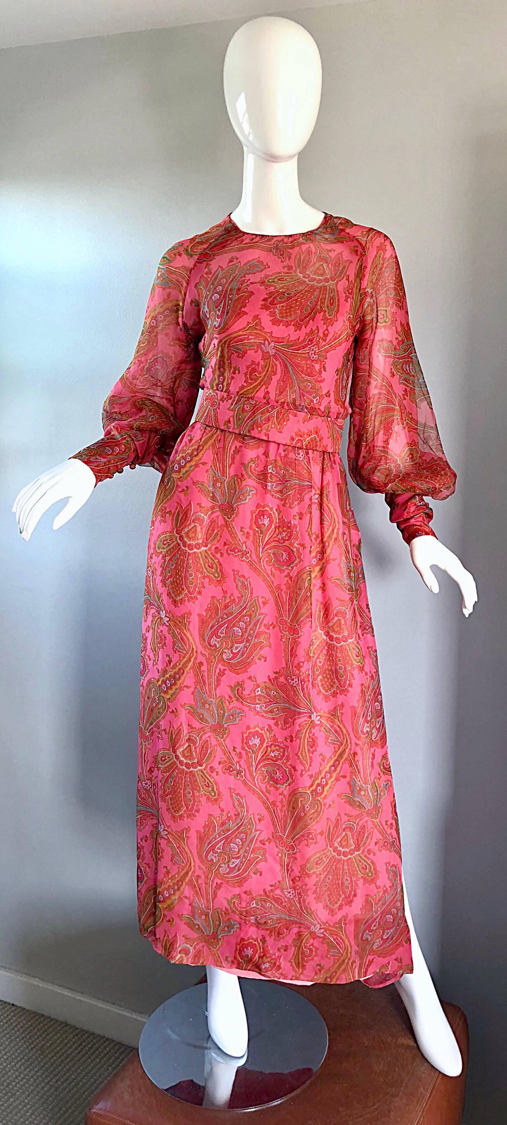 Gorgeous early 70s ADELE SIMPSON silk chiffon pink paisley gown! Features a vibrant paisley print in pink, green, orange, blue and yellow. Fitted bodice, with a slightly full skirt. Slit up the left leg reveals just the right amount of skin. Full
