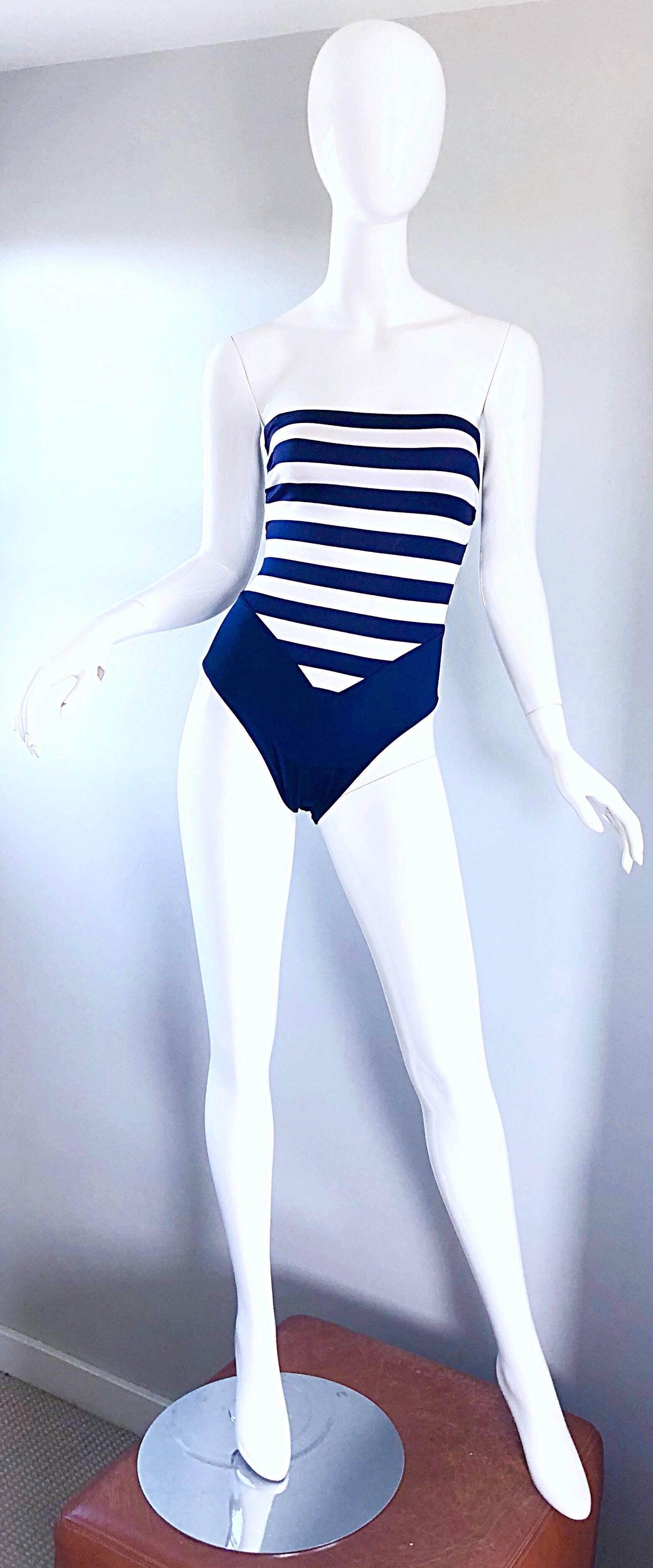 Sexy 1990s BILL BLASS navy blue and white striped one piece swimsuit or bodysuit! Features navy and white stripes throughout. Sexy lace up back reveals just the right amount of skin, and makes this gem accessible to an array of sizes. 
In great