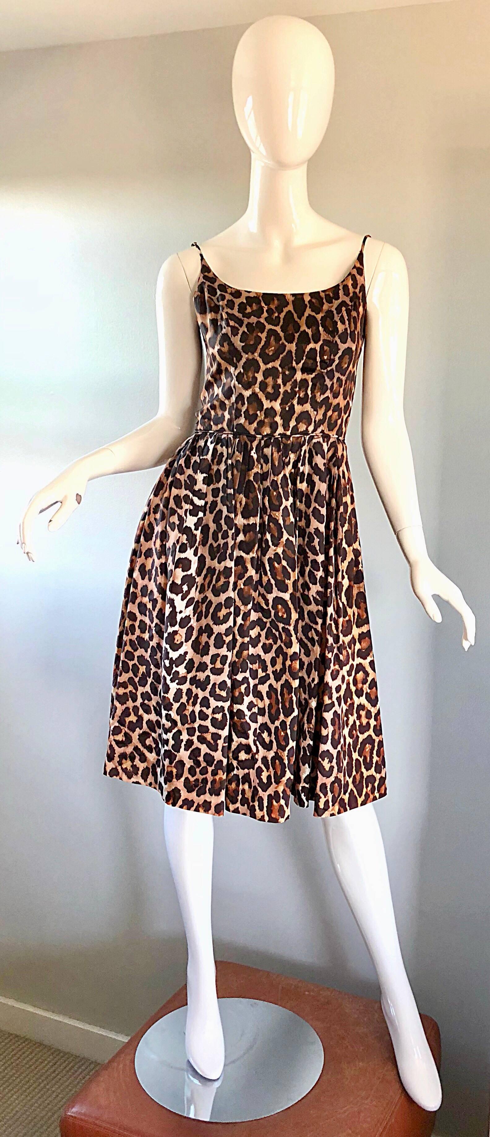 Gorgeous vintage 1950s demi couture leopard/cheetah print fit and flare silk dress! This is one bombshell of a dress, and is a classic beauty! Features allover animal print. Fitted bodice with a full forgiving skirt. Full metal zipper up the back