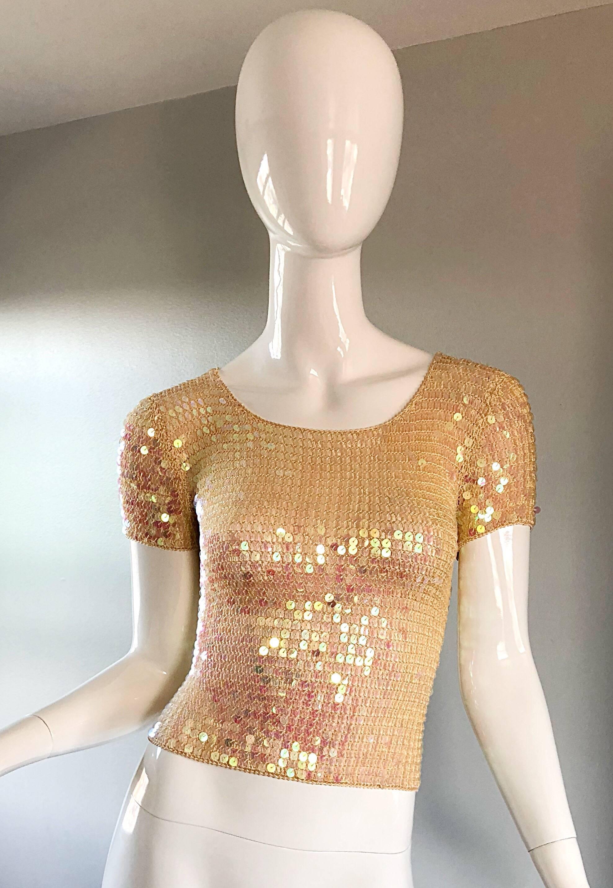 Fabulous sexy 90s pink champagne knit crochet sequin crop top! Features a pink champagne colored soft knit crochet with thousands of hand-sewn iridescent sequins throughout. Simply slips over the head, and stretches to fit. Unique color matches 