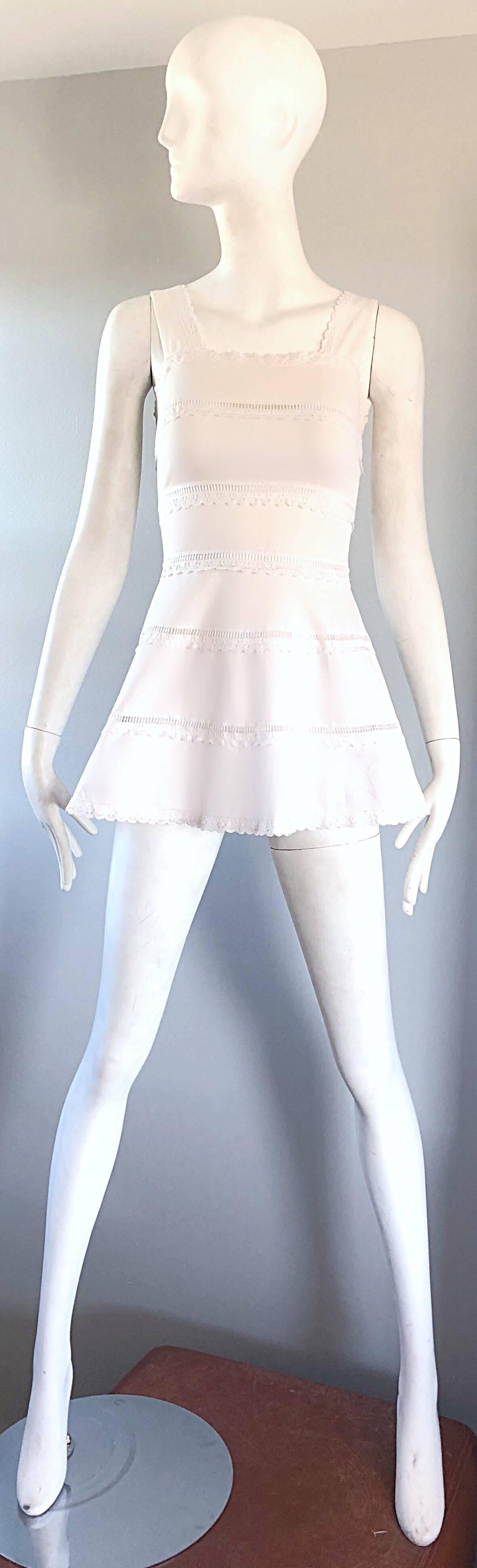 Chic 1960s white mod knit A - Line mini dress or tunic top! Features cut-out details on each panel that reveal just the right amount of skin (it is hard to see on the mannequin, but each horizontal panel has crochet cut-outs). Hidden zipper up the