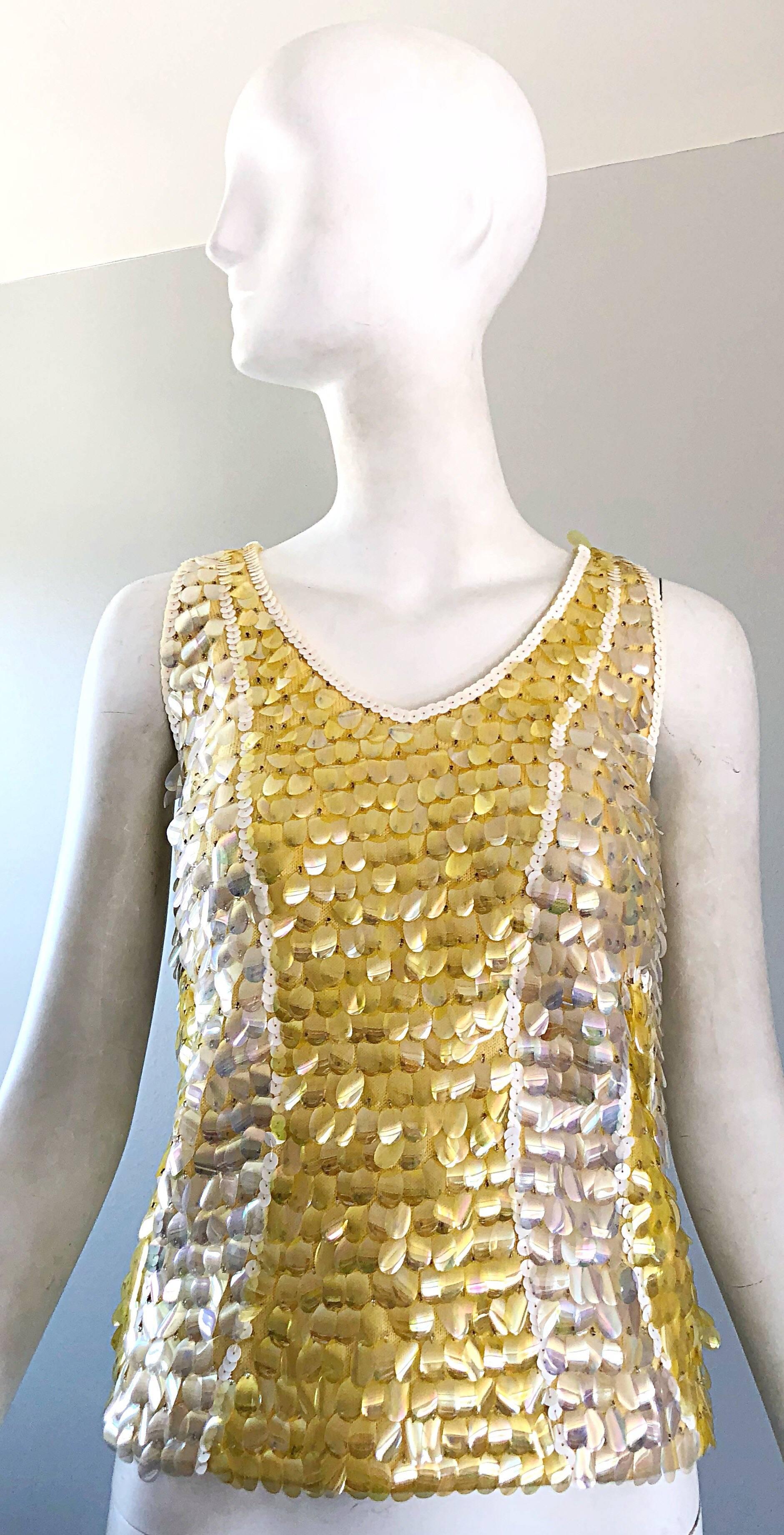 Chic vintage 1960s yellow, white and clear paillettes and sequin encrusted sleeveless lamb's wool sweater top! Features hundreds of hand-sewn sequins and paillettes throughout. Super soft luxurious lamb's wool, and fully lined in rayon. Full metal