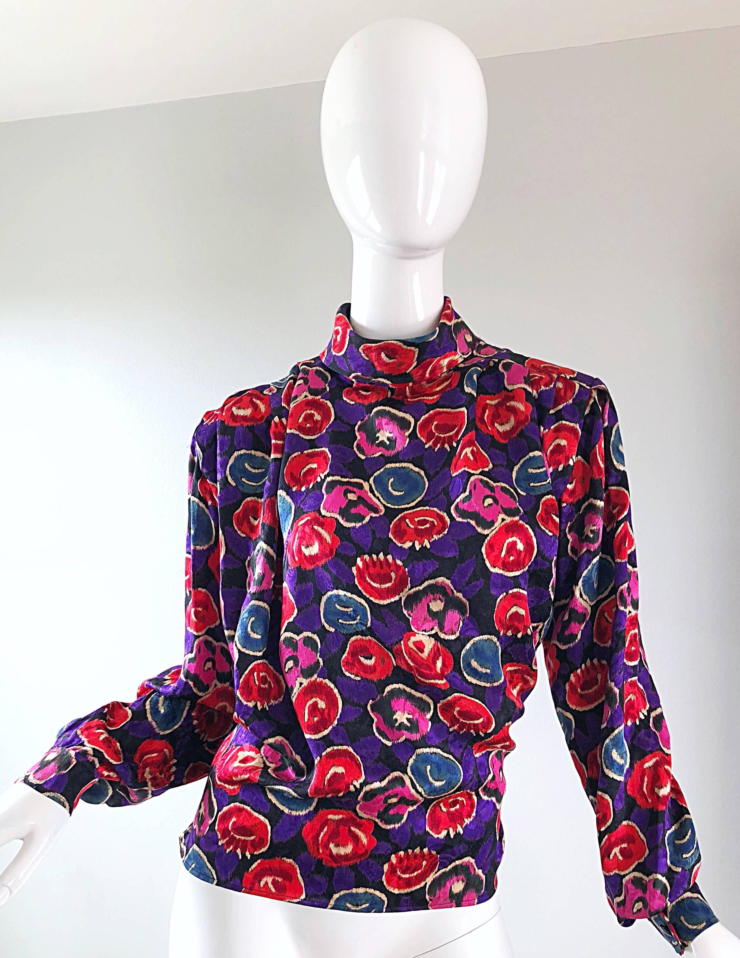 Beautiful vintage early 90s EMANUEL UNGARO for BERGDORF GOOFMAN high neck flower print long sleeve blouse! This top has it all! Chic blousy fit, high neck, and dolman sleeves! Flowers in vibrant colors of pink, red and blue with a rich regal purple