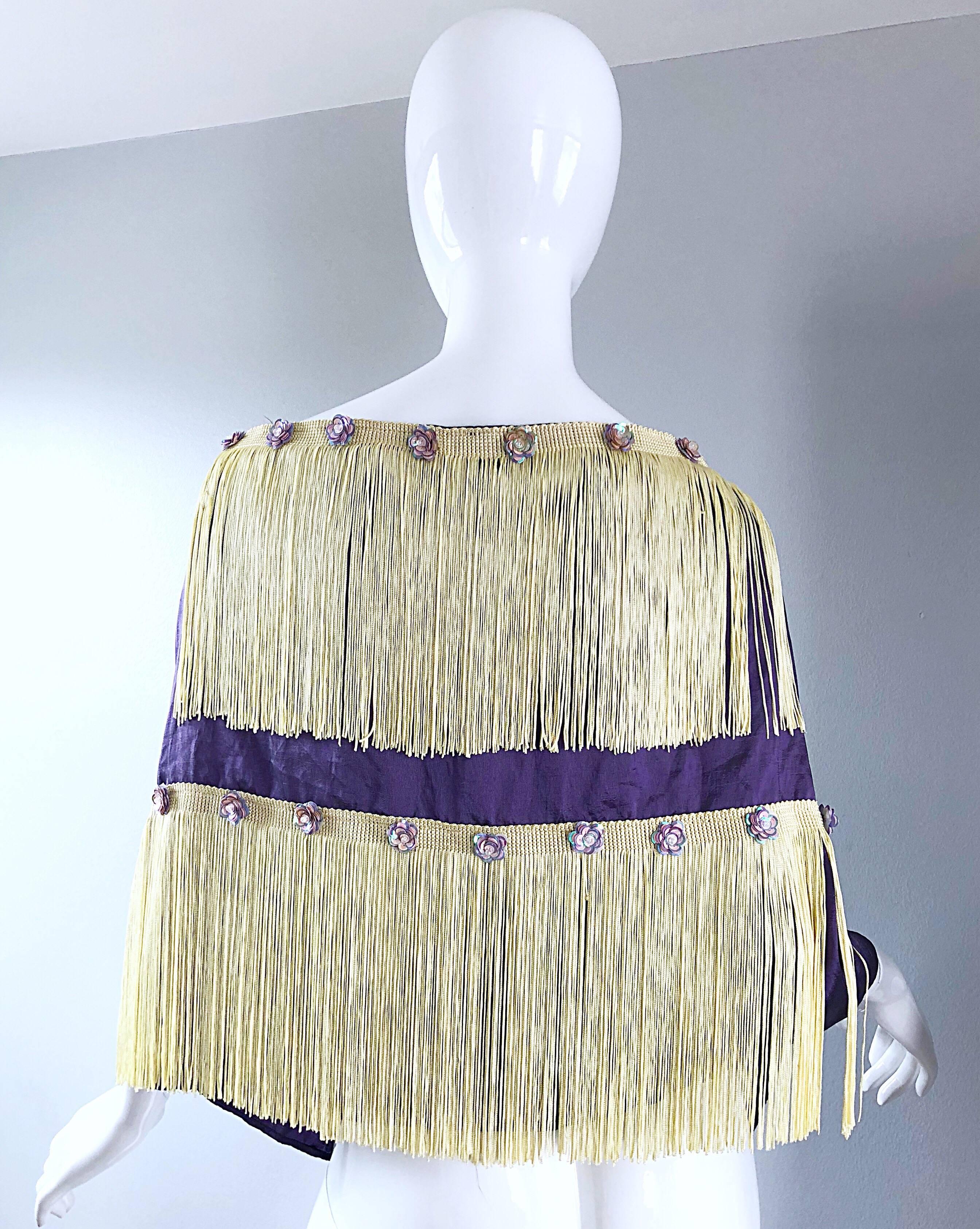 Beautiful 1950s purple and ivory fringed sequined large shawl / stole! Features a soft purple / lavender color with two layers of ivory fringe. Iridescent purple sequins in the shape of flowers hand-sewn throughout. The perfect accessory that can