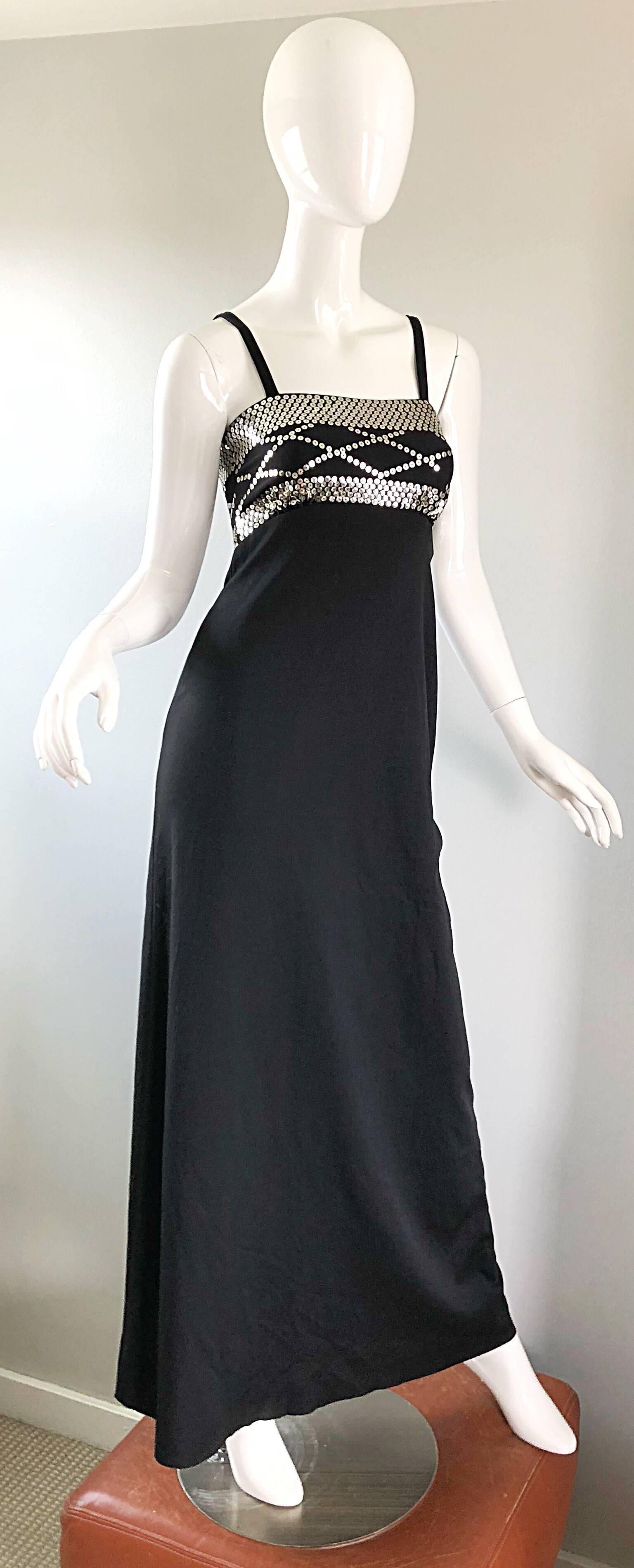 Disco chic 1970s black and silver jersey maxi dress! Features silver sequins at the bust in geometric shapes. Stretch jersey is lightweight and comfortable. Hidden zipper up th eback with hook-and-eye closure. Great with sandals, wedges or heels.