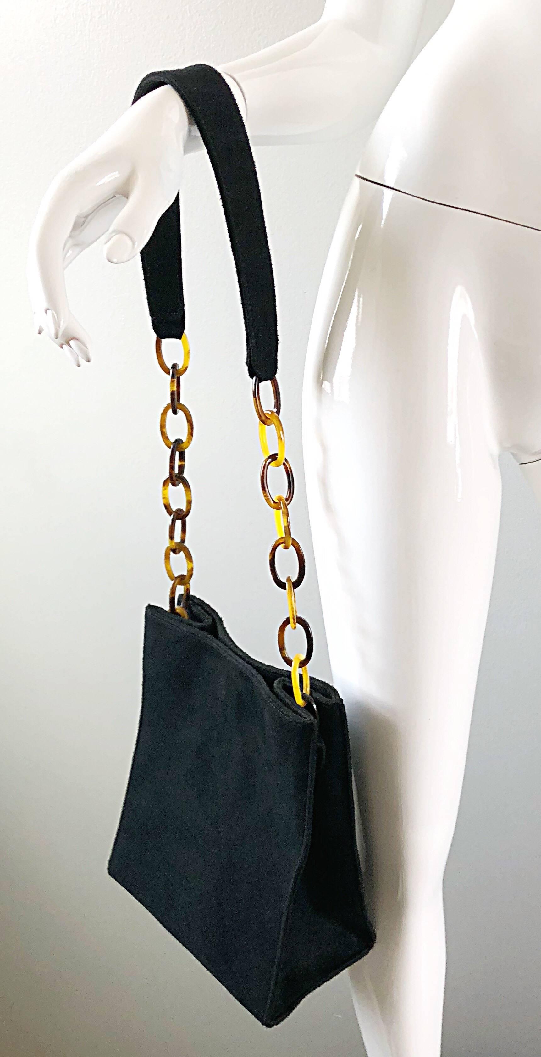 Chic and classic RAQUEL SITWELL black suede and faux tortoise shell structured shoulder bag! Medium to Large size fits all the necessities. Long shoulder strap is the perfect length to easily sit on the shoulder. Eight faux tortoise shell links on