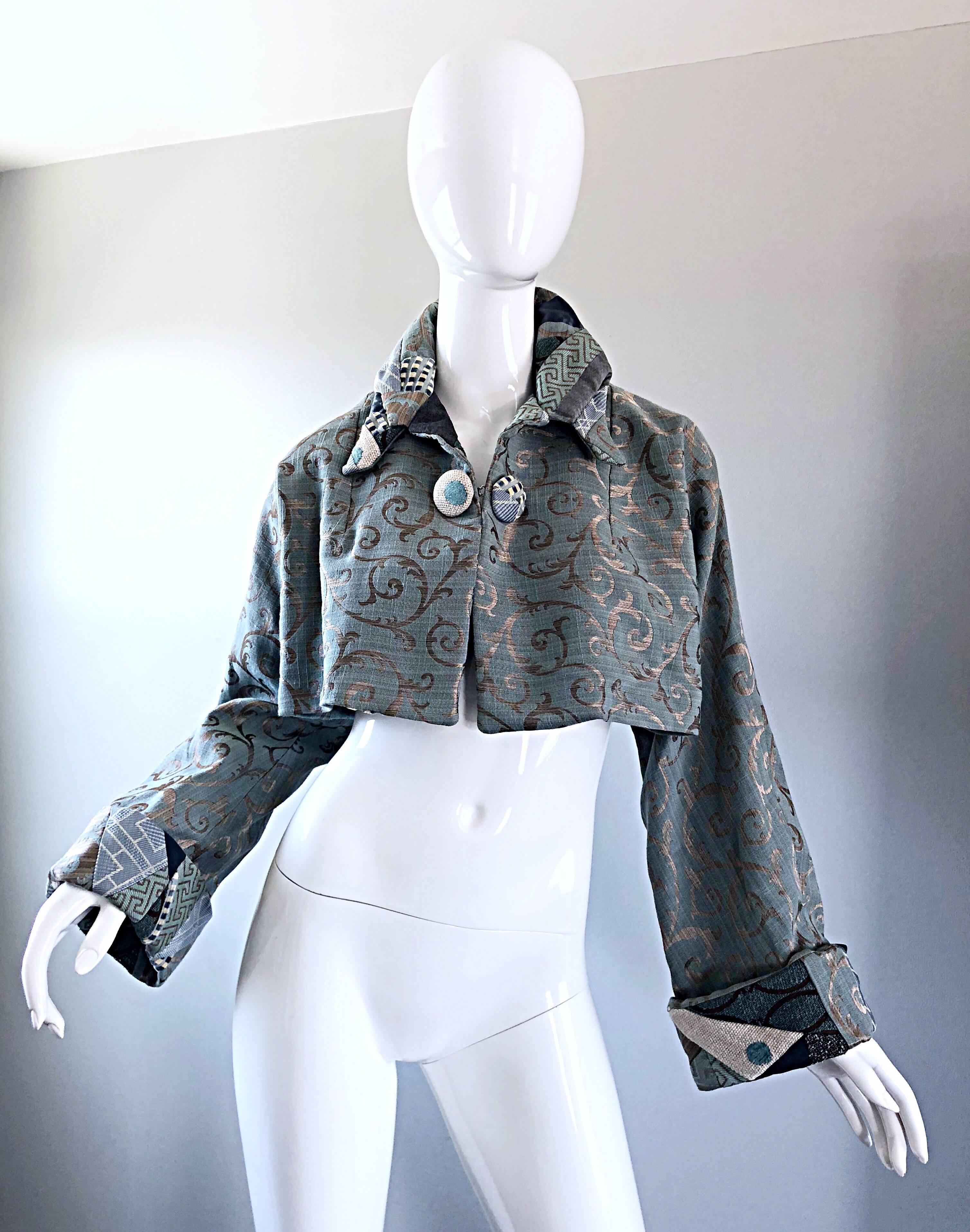 Incredible 1990s couture quality light blue and taupe baroque print silk crop bolero jacket! Trapeze like fit which flares in the back. Dolman sleeves make this gem easy to wear for an array of sizes. Beautiful sky blue color with a regal elegant