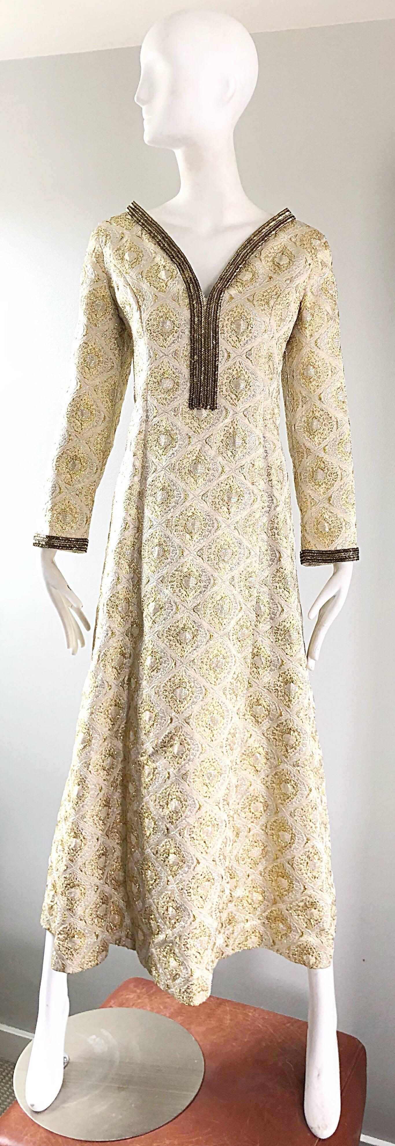 Amazing vintage 1970s gold and silver silk brocade beaded Moroccan kaftan / maxi dress! Features an iridescent gold and silver with bronze beads around the collar and each sleeve cuff. Full metal zipper up the back with hook-and-eye closure. 
Great