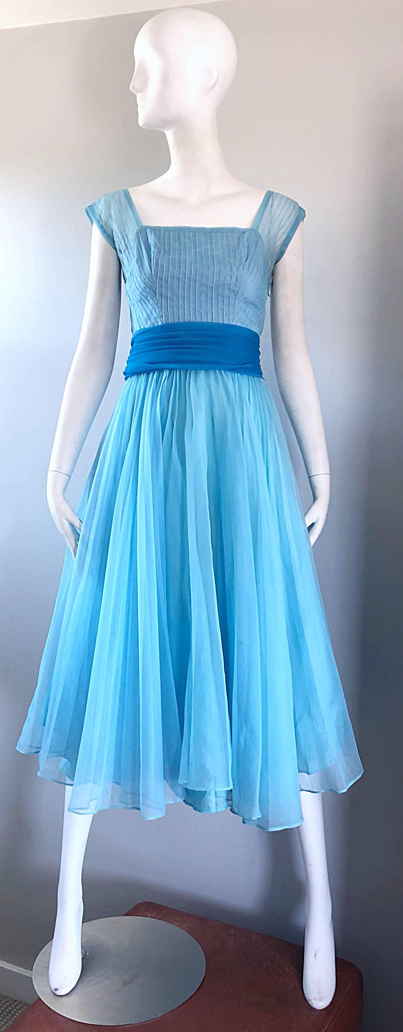 Beautiful 1950s FRED PERLBERG robin eggs blue fit n' flare dress! Features a ribbed fitted bodice with cap sleeves. Full forgiving skirt with attached sash belt. Full metal zipper up the side with hook-and-eye and snap closures. Very well made, with