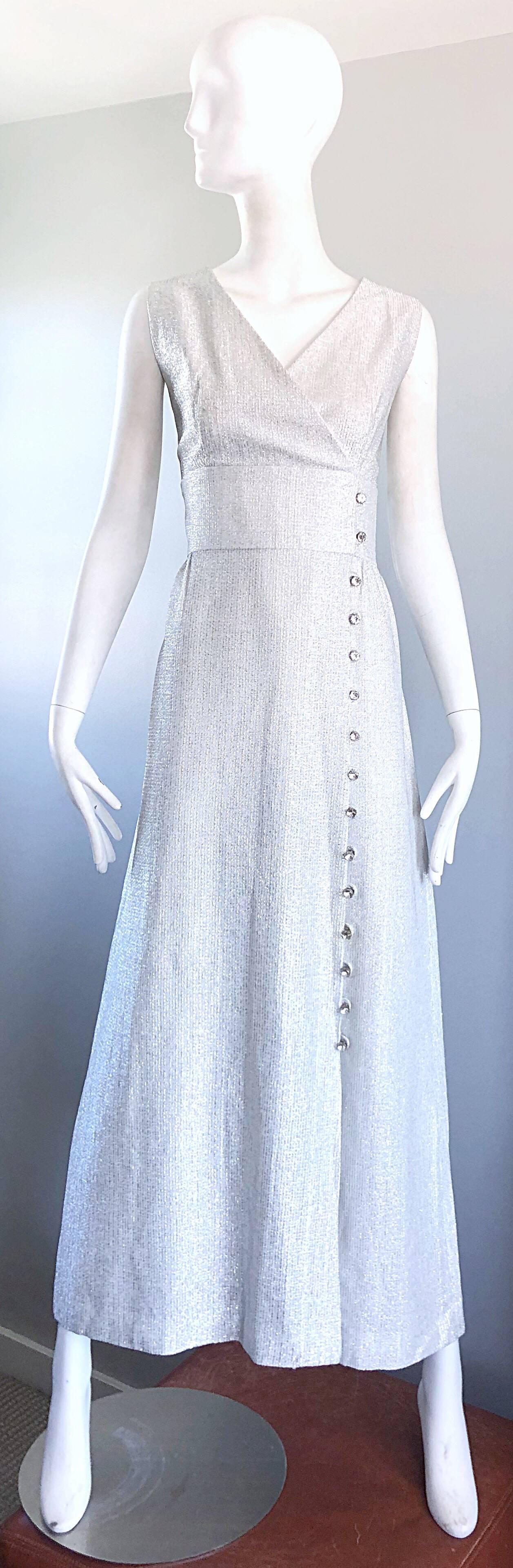 Beautiful vintage 70s silver metallic lurex sleeveless 
maxi dress / gown with rhinestone buttons! Features a soft silver metallic lurex that is both elegant and flattering. Fitted bodice with a flattering full skirt. Rhinestone buttons down the