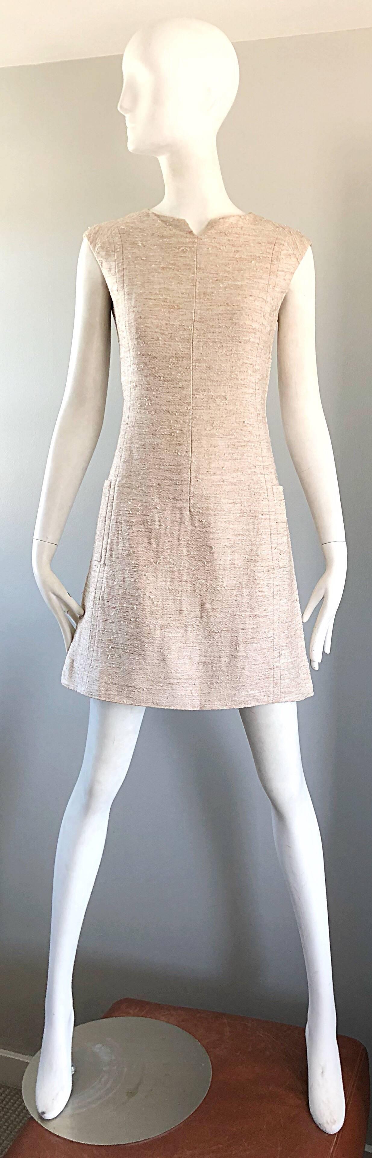 Chic 1960s oatmeal / beige colored Irish Linen A-Line dress! Features a textured tweed-like soft linen. Fitted bodice with a forgiving flattering A Line skirt. Pockets at each side of the waist. Full metal zipper up the back with hook-and-eye