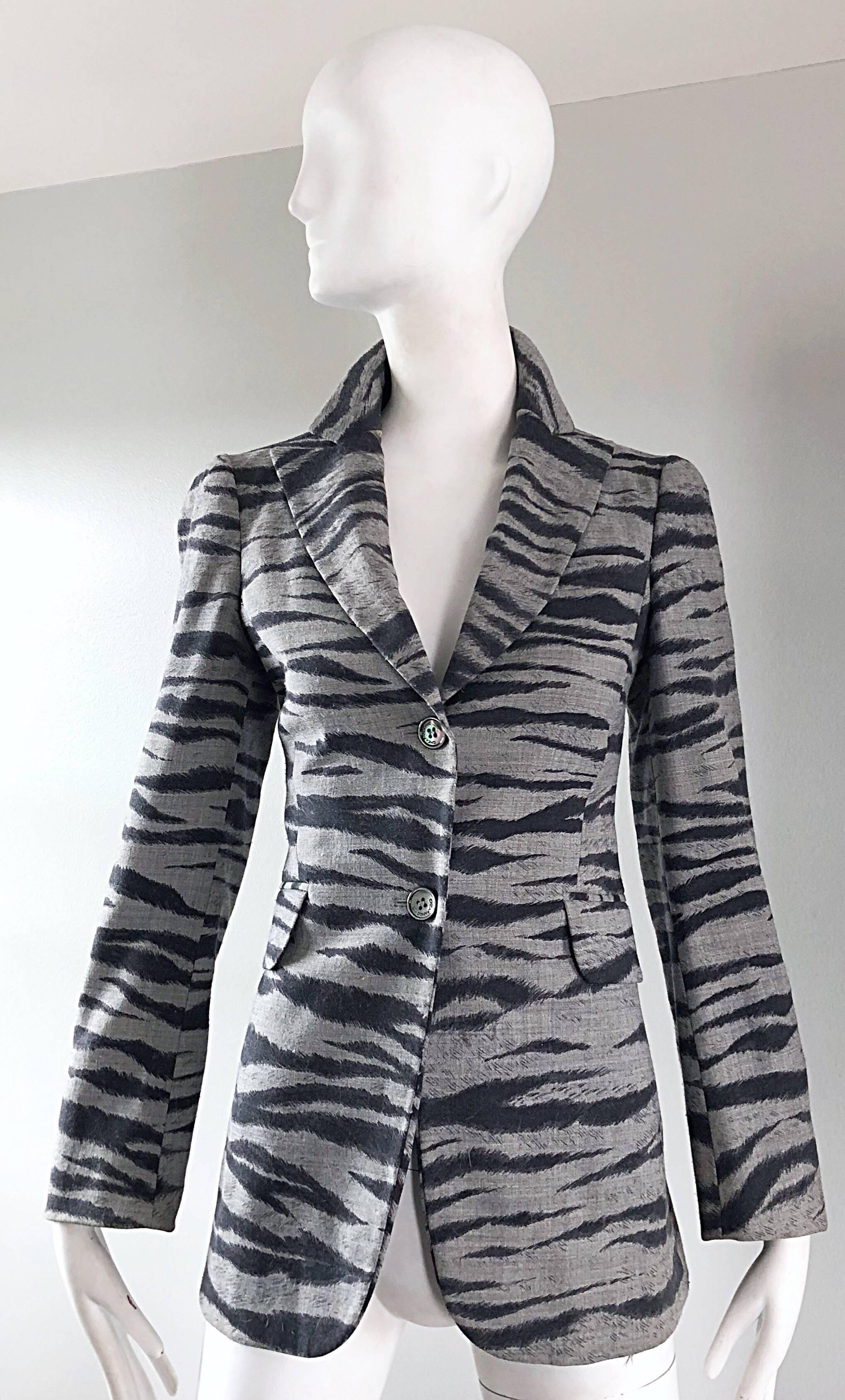 Stylish vintage 90s MOSCHINO CHEAP & CHIC grey and black zebra animal print blazer jacket! Amazing tailored silhouette flatters the figure. Two buttons up the front, with pockets at each side of the waist. Fully lined. Wear with the collar popper