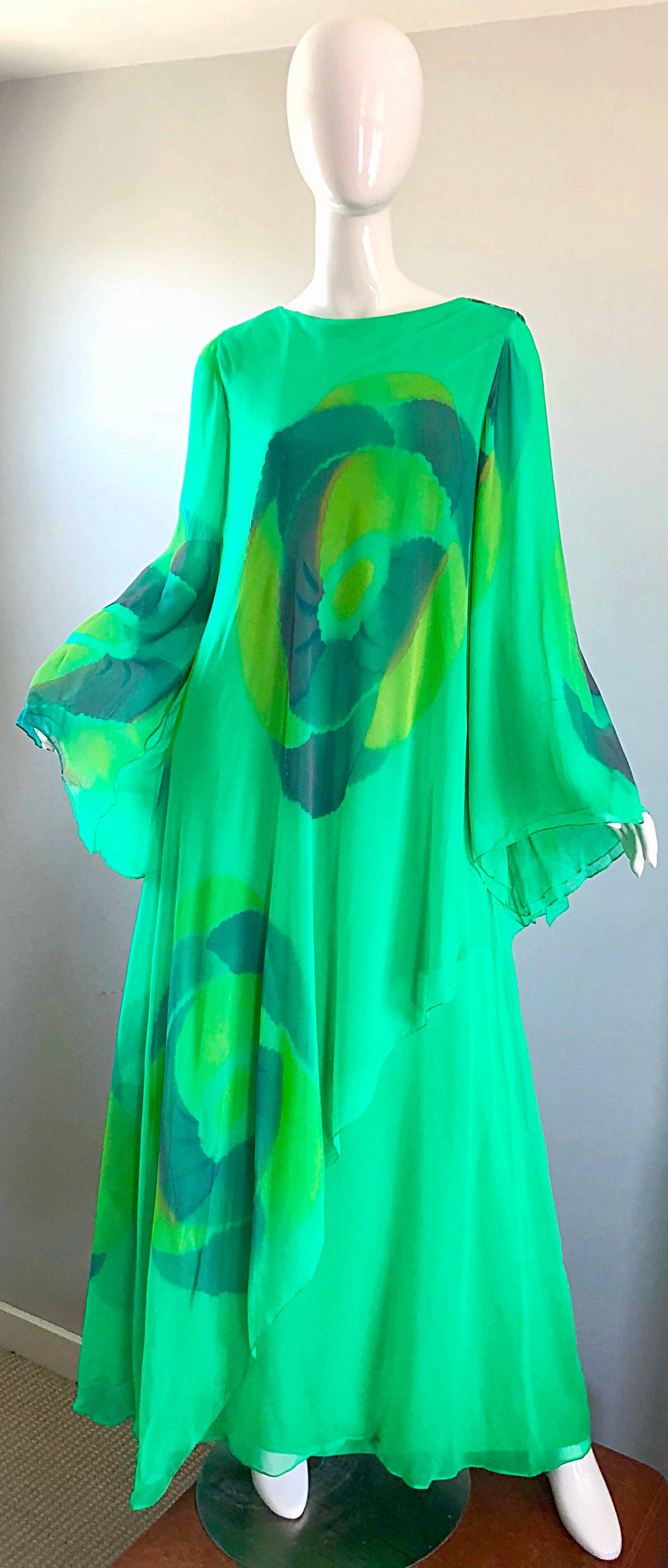Absolutely stunning 1970s TRAVILLIA hand painted kelly green caftan gown! Features layers upon layers of the finest silk chiffon. Hand painted watercolor prints throughout the front, back and sleeves. Forgiving loose fit drapes the body