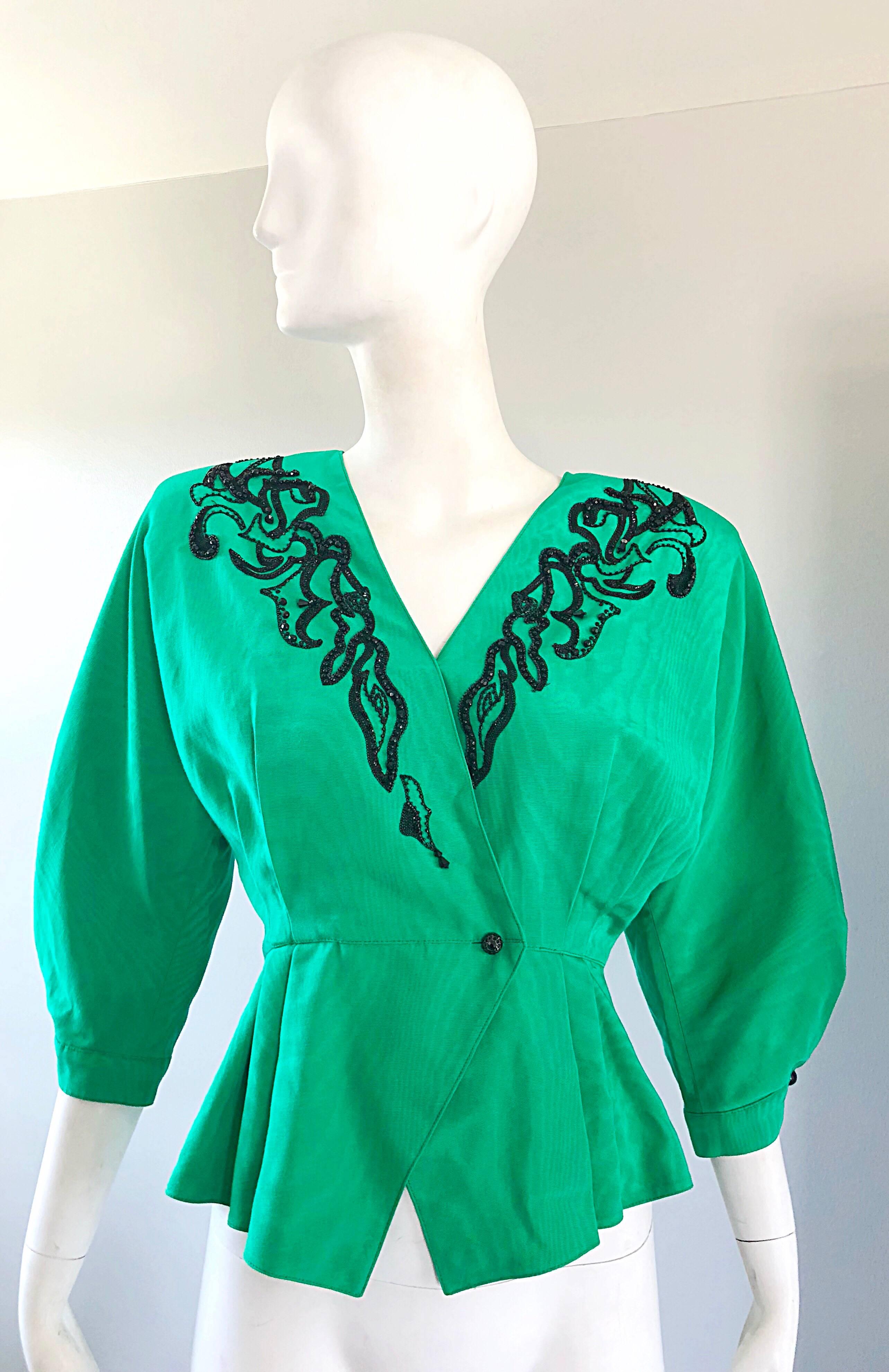 Gorgeous vintage 80s EMANUEL UNGARO kelly green silk moire Avant Garde beaded peplum jacket! Features a vibrant kelly green color with hundreds of hand sewn black seed beads along the neck. Single button jacket with interior hook-and-eye closure.