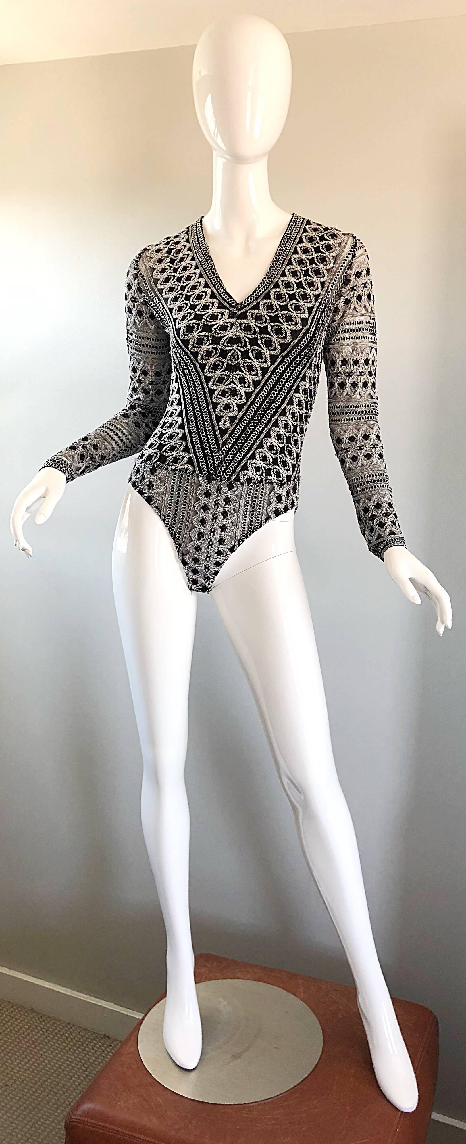 Sexy 1990s French made black and white long sleeve knit bodysuit! Soft black and white knit, with intricate details, stretches to fit. Semi sheer sleeves reveal just the right amount of skin. Fantastic flattering fit! Great with jeans, shorts or a