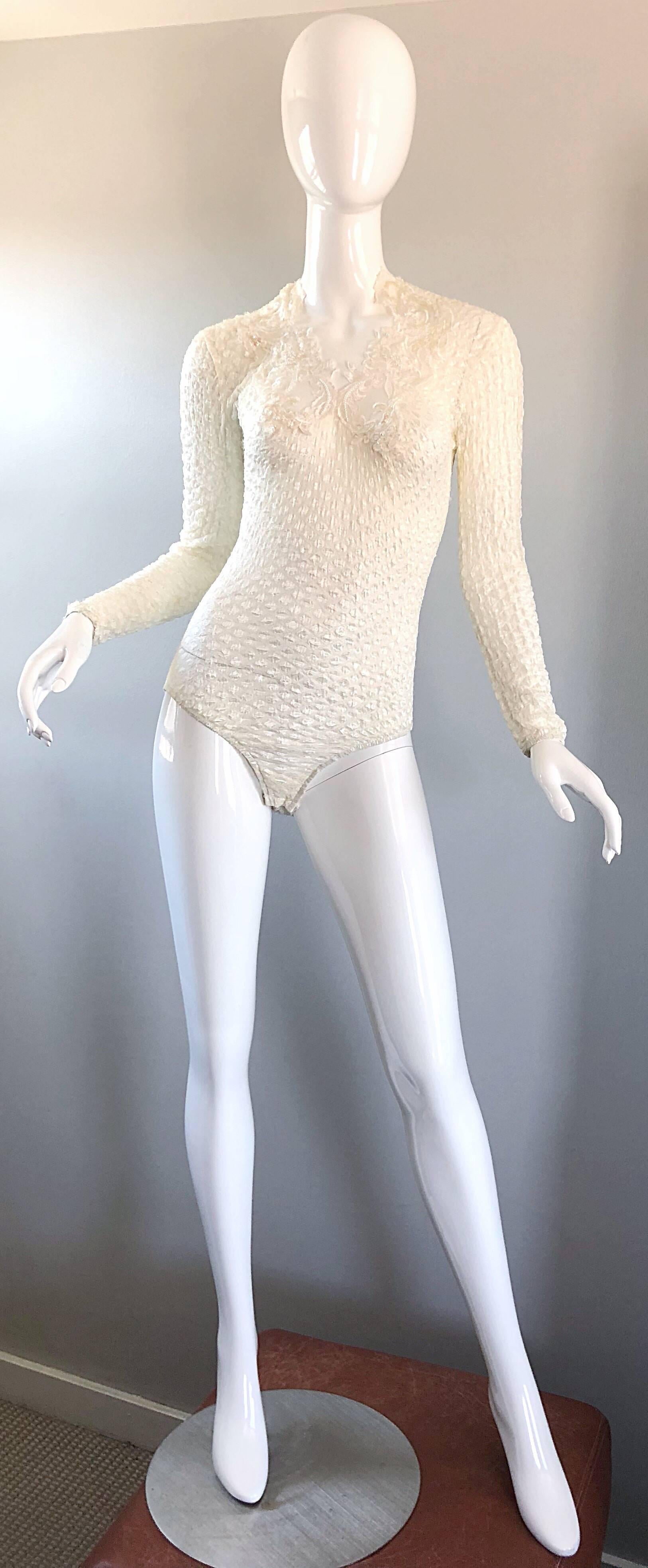 Sexy vintage 90s GEORGES BARHEL of Paris white long sleeve cut-out one piece bodysuit! Features cut-out details along the neck, with hand-sewn iridescent sequins throughout. Sleek tailored fit that has plenty of stretch. Great with jeans, shorts,