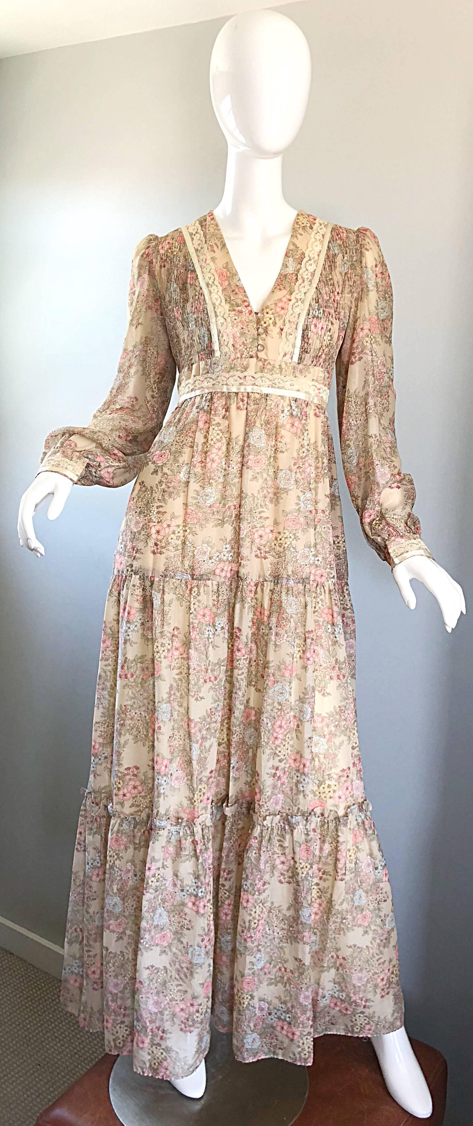 Pretty vintage 1970s lightweight cotton voile and lace flower print long sleeve maxi dress! Beige background, with light shades of pastel pink, green, yellow and blue throughout. Buttons up center bodice with lace trim along the neck, sleeve cuffs