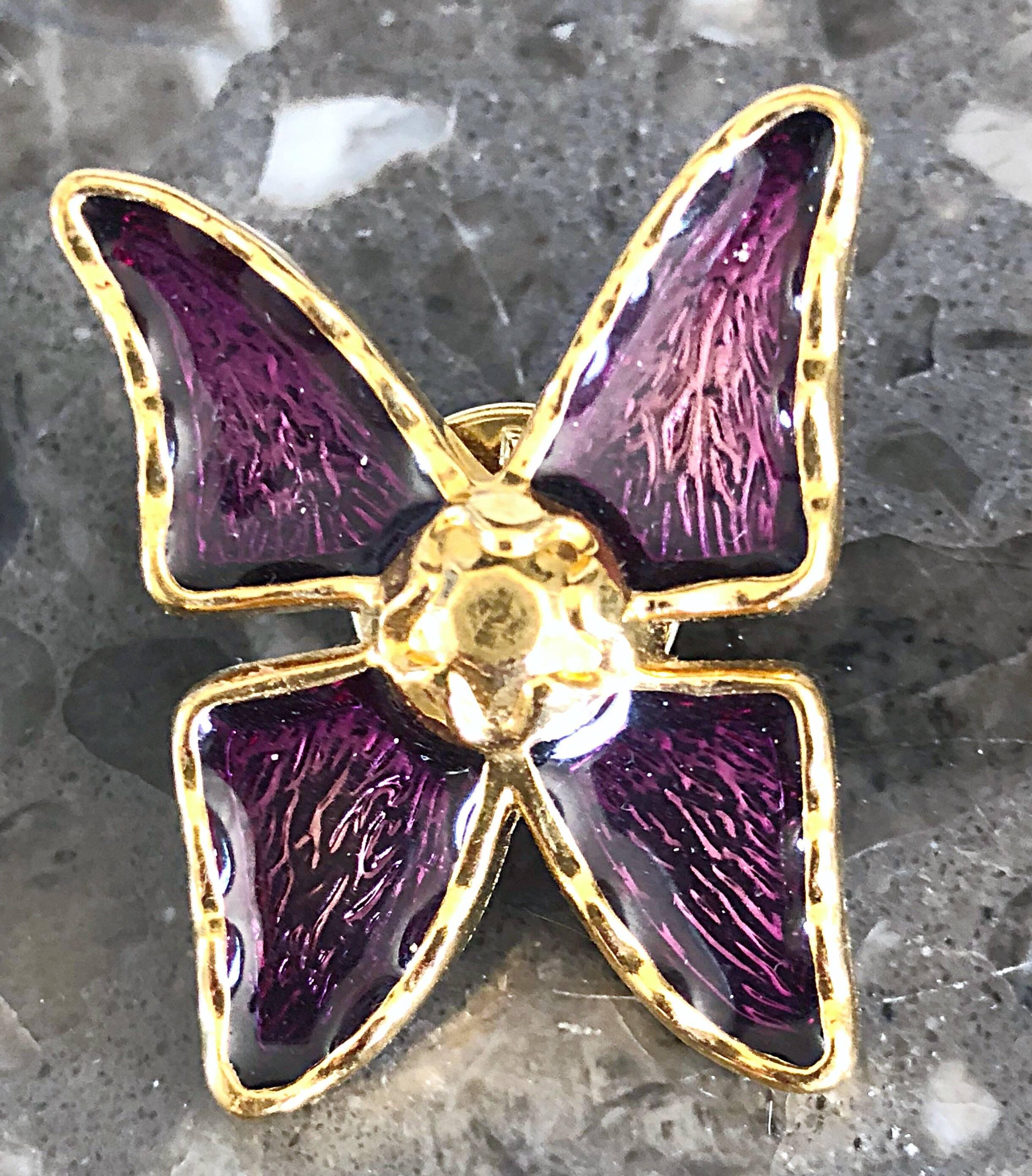 Add a little something to any outfit with this vintage 
YVES SAINT LAURENT purple and gold brooch pin! Features a beautiful regal jewel tone. In great condition. Made in France
