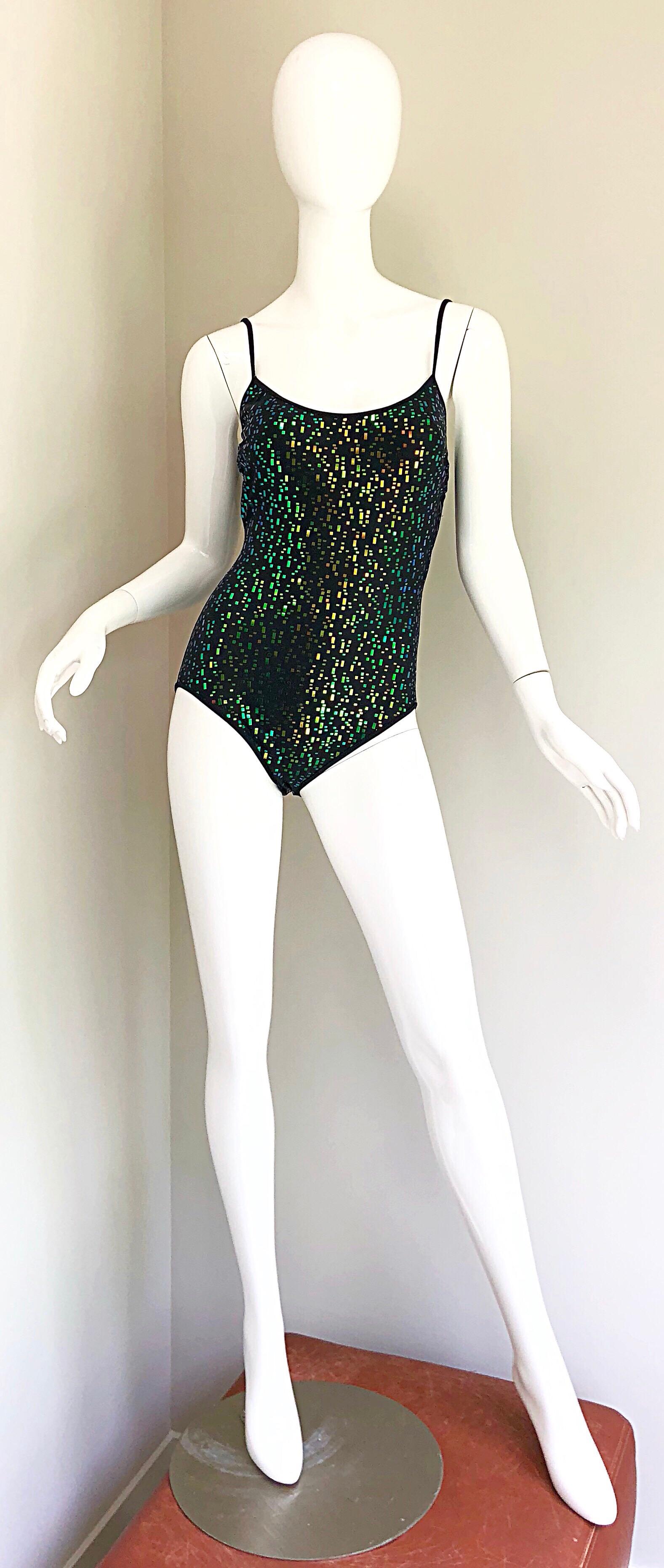 Sexy vintage 1990s deadstock (new w/ tags) OSCAR DE LA RENTA black sequin one piece swimsuit or bodysuit! Features iridescent blue and green sequins throughout. Solid black flattering back. Simply step into this rare gem, and go. Great for the