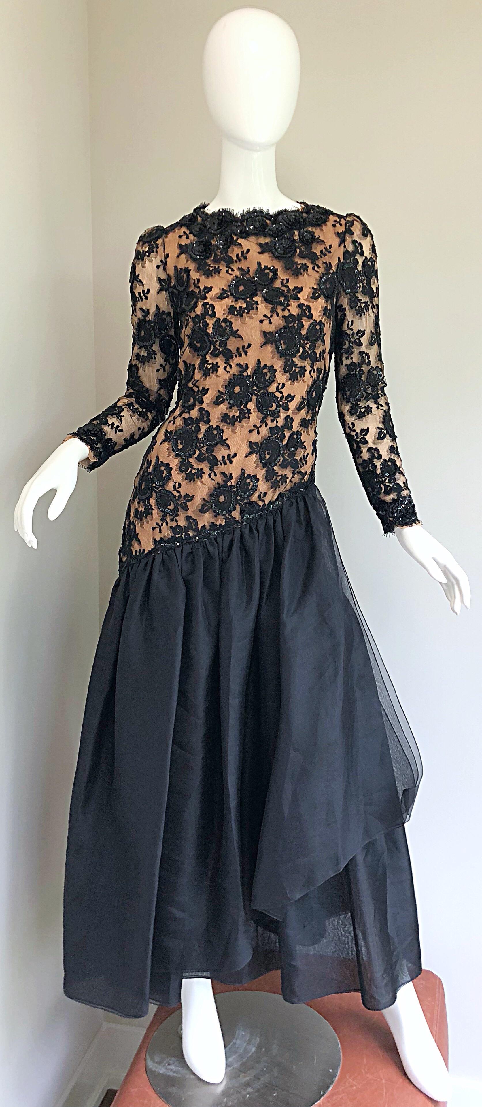 Gorgeous vintage 1990s BILL BLASS black French lace and nude silk chiffon sequined mermaid hem long sleeve drop waist evening gown! Features a fitted bodice with nude chiffon underlay, and black French lace over. Hundreds of hand-sewn black sequins