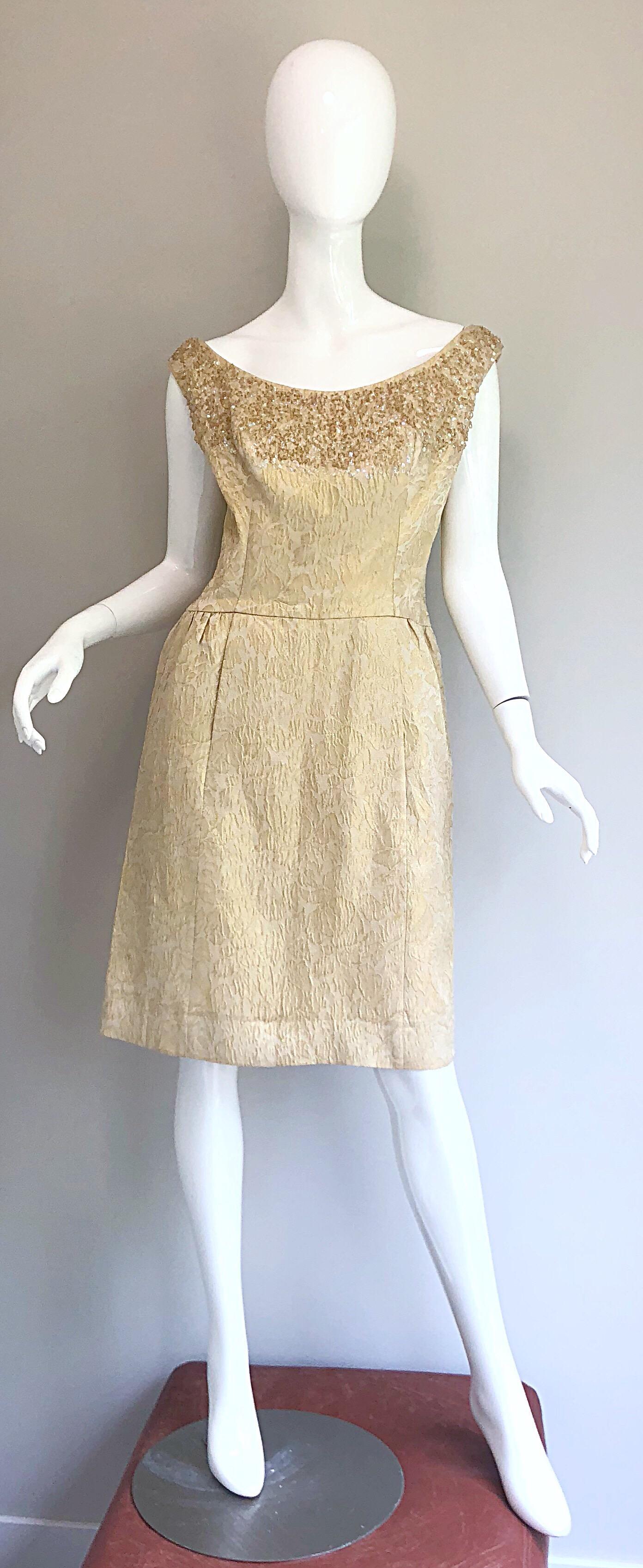Pretty 1950s larger size couture quality gold metallic silk brocade sequined and beaded cocktail dress! Features a luxurious gold silk brocade fabric. Hundreds of hand-sewn iridescent sequins and beads throughout the top front and back bodice.