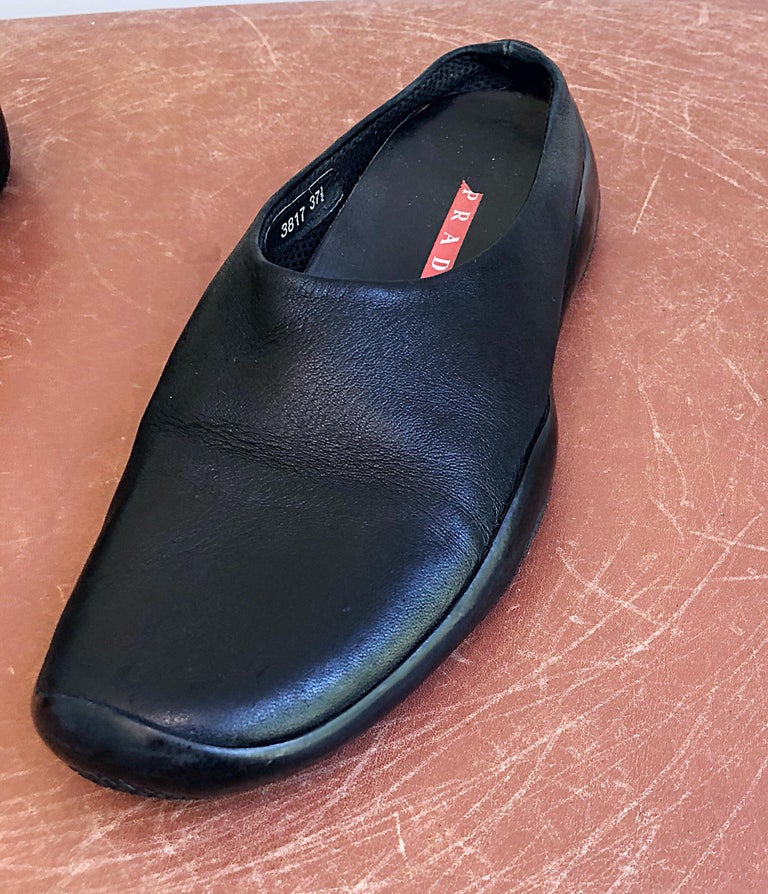 Chic, yet comfortable late 90s PRADA black leather open-back clogs / mules! Super soft rubber sole is perfect for all day wear. Great it's shorts, jeans, a skirt or even a dress. In great condition (appears to only have been worn a handful of