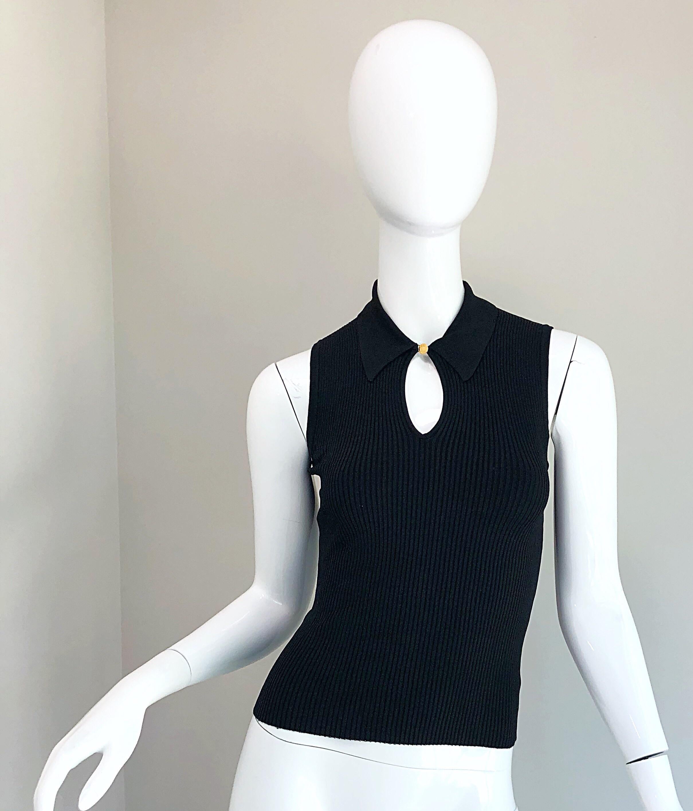 Stylish vintage HERMES black ribbed stretch shirt! Features a single gold logo embossed button at center neck. Simply slips over the head. The perfect staple piece that can easily be dressed up or down. The pictured 1990s KRIZIA rhinestone encrusted