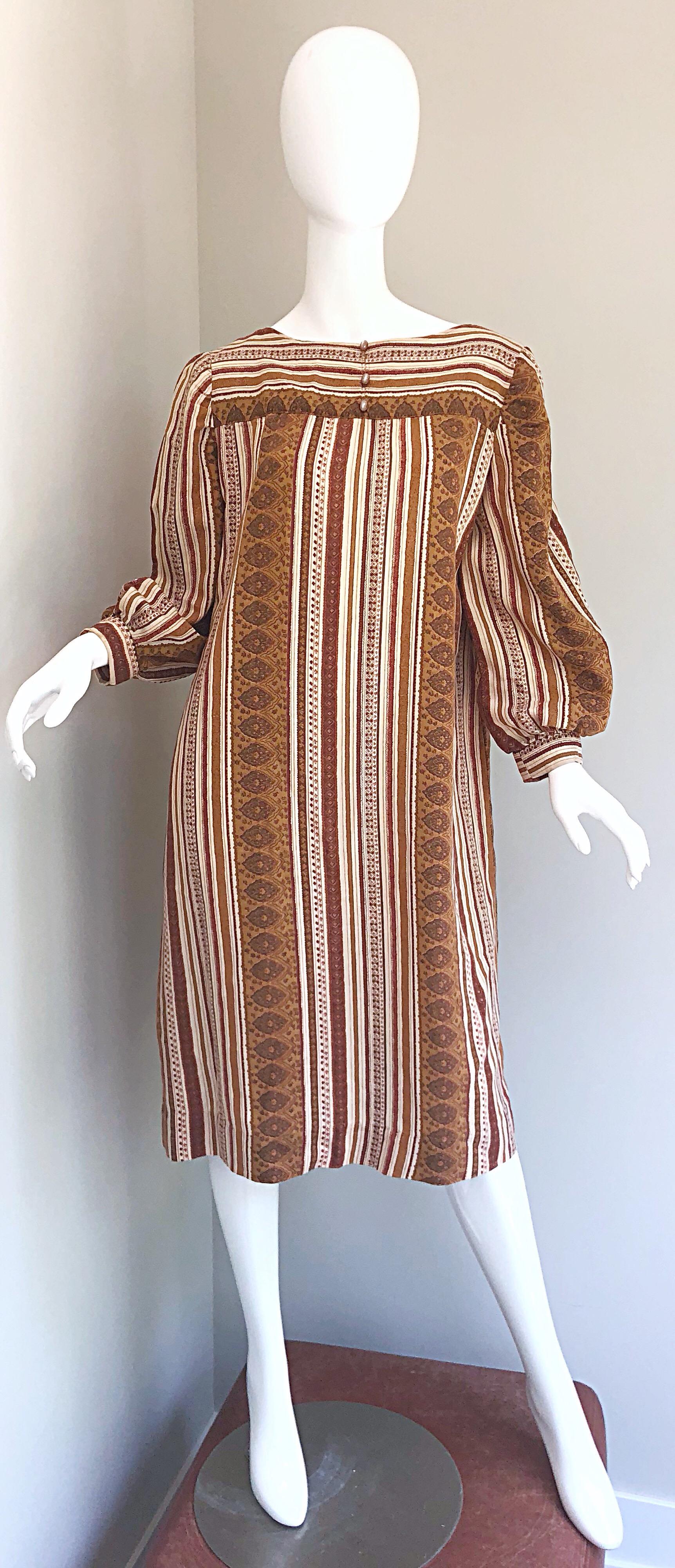 Boho chic brown, tan and ivory cotton sac dress! Reminiscent of the Yves Saint Laurent 1976 Russian Collection, this easy to wear gem is both stylish and comfortable. Features three mock buttons at center neck. Simply slips over the head. Great