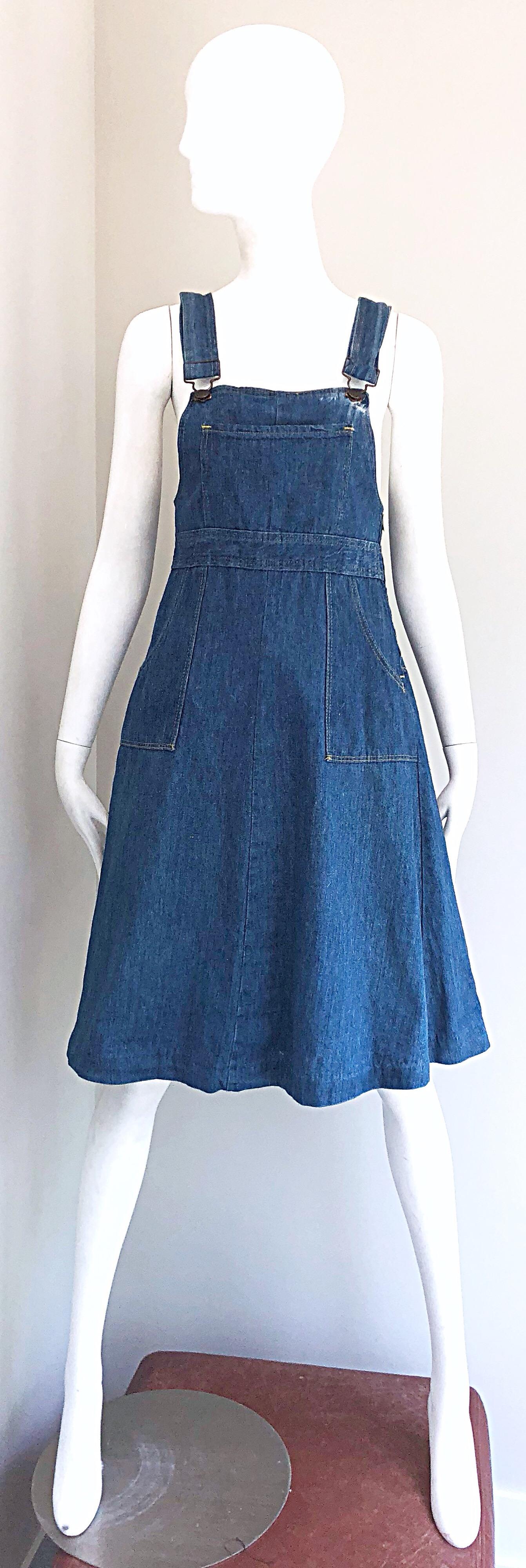 Rare early 1970s THE GAP denim overalls blue jeans dress! From one of the first to collections from The Gap in 1971. Features a fitted bodice itch an A-Line skirt. Pockets at each side of the hips and at center bust. Hidden zipper up the side.