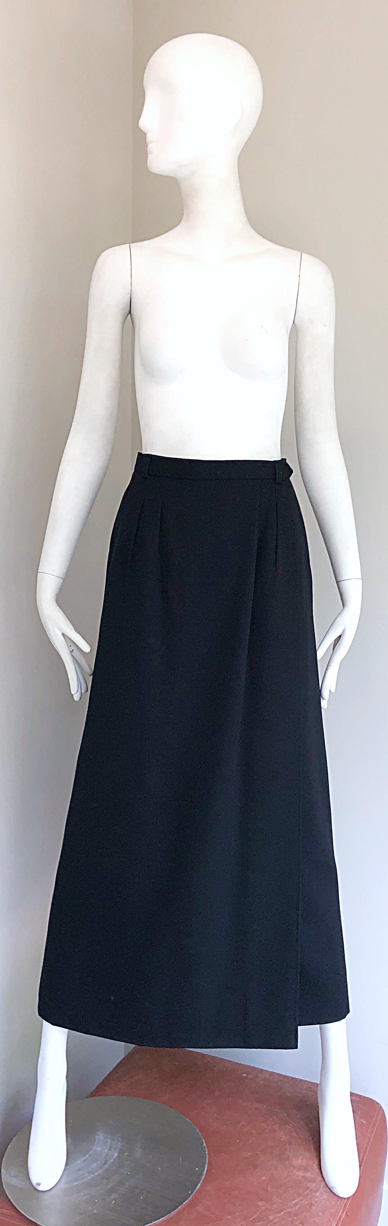 Chic, yet classic vintage late 70s YVES SAINT LAURENT Rive Gauche black wool wrap maxi skirt! Features an interior button with hook-and-eye closure. POCKETS at each side of the waist. Fully lined. Belt loops to accomodate your favorite belt.
A truly