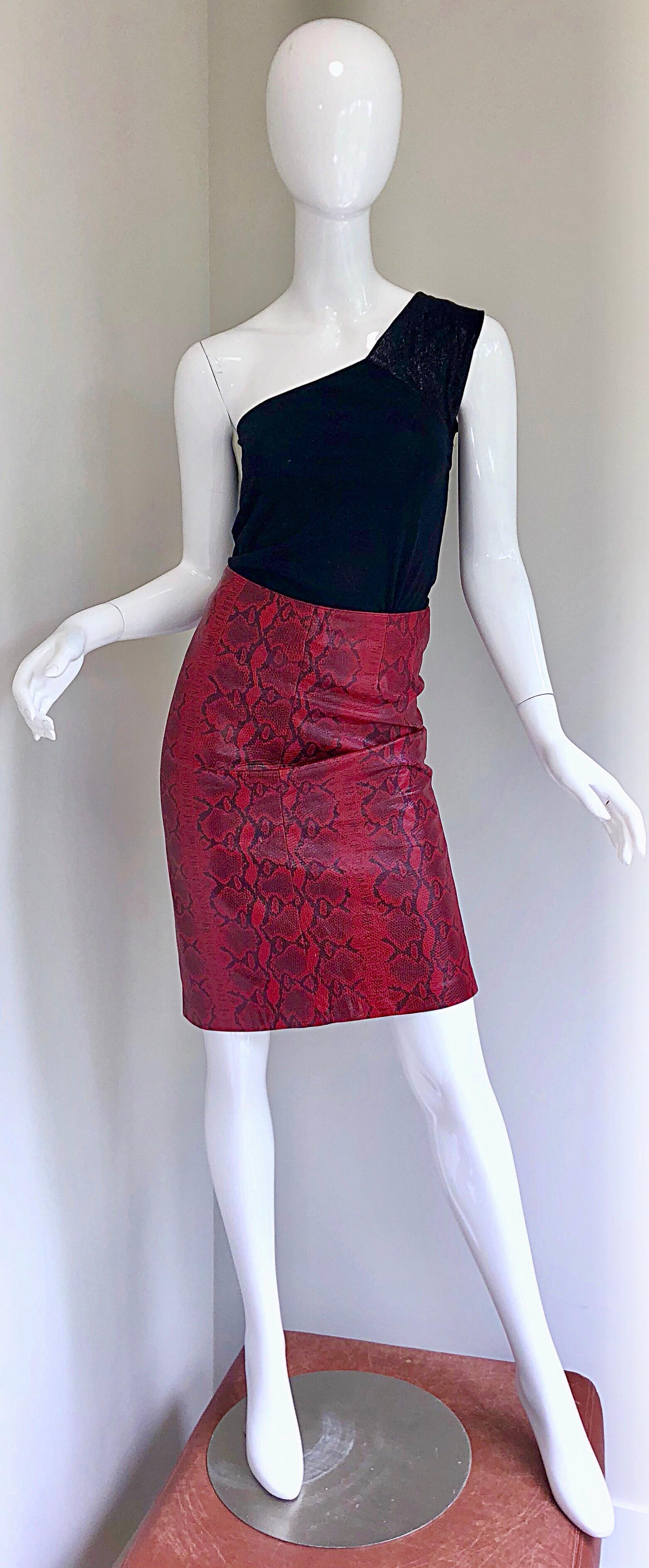 Sexy 1980s red leather snakeskin print high waisted pencil skirt! Features a classic red and black animal print throughout. Hidden zipper up the back with button closure. Fully lined. Can easily be dressed up or down. The pictured black GUCCI by TOM