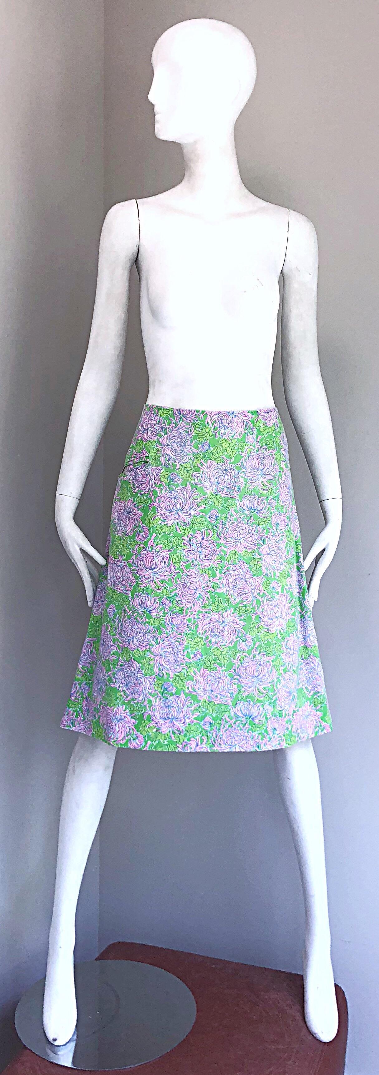Rare Early LILLY PULITZER 1960s neon green and pink flower carnation print cotton A - Line skirt! Features vibrant colors of green, pink and blue throughout. POCKET at the right side of the hip. Hidden metal zipper up the side with hook-and-eye