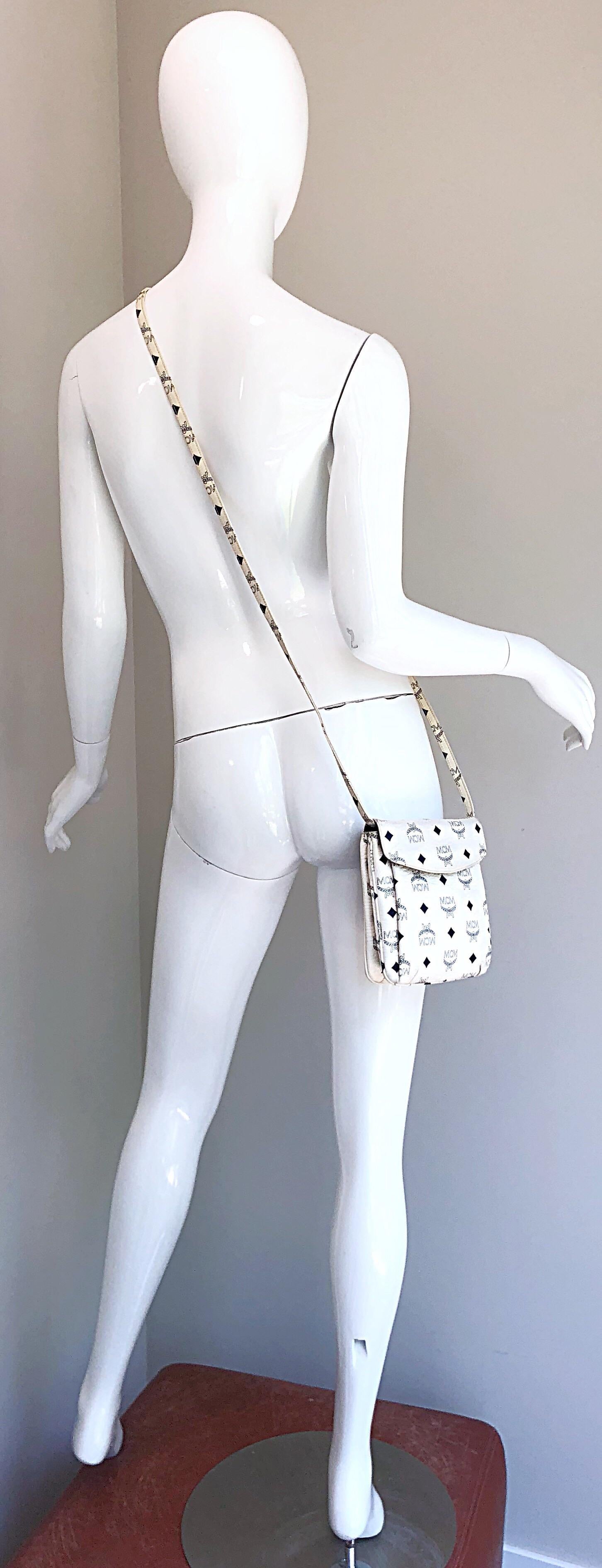 Awesome vintage MCM original, by Michael Cromer, unisex 1970s black and white logo encrusted small cross body bag, OR clutch ! Features all the necessary pockets and secure closure that make this rare gem perfect for traveling. Adjustable strap can