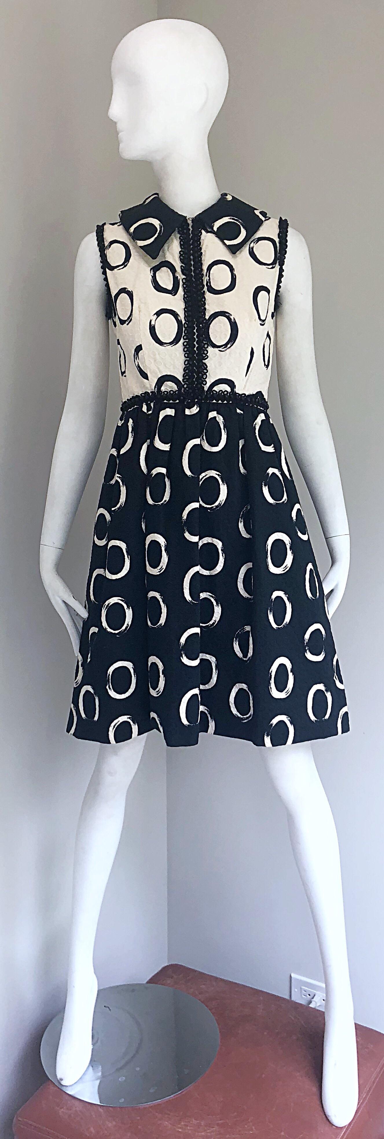 Chic vintage 1960s OSCAR DE LA RENTA black and white (light ivory) beaded sleeveless A-Line cotton pique dress! Features the rare early signature 'O' print throughout. Black embroidery at each sleeve, down the front bodice, and waistband with black