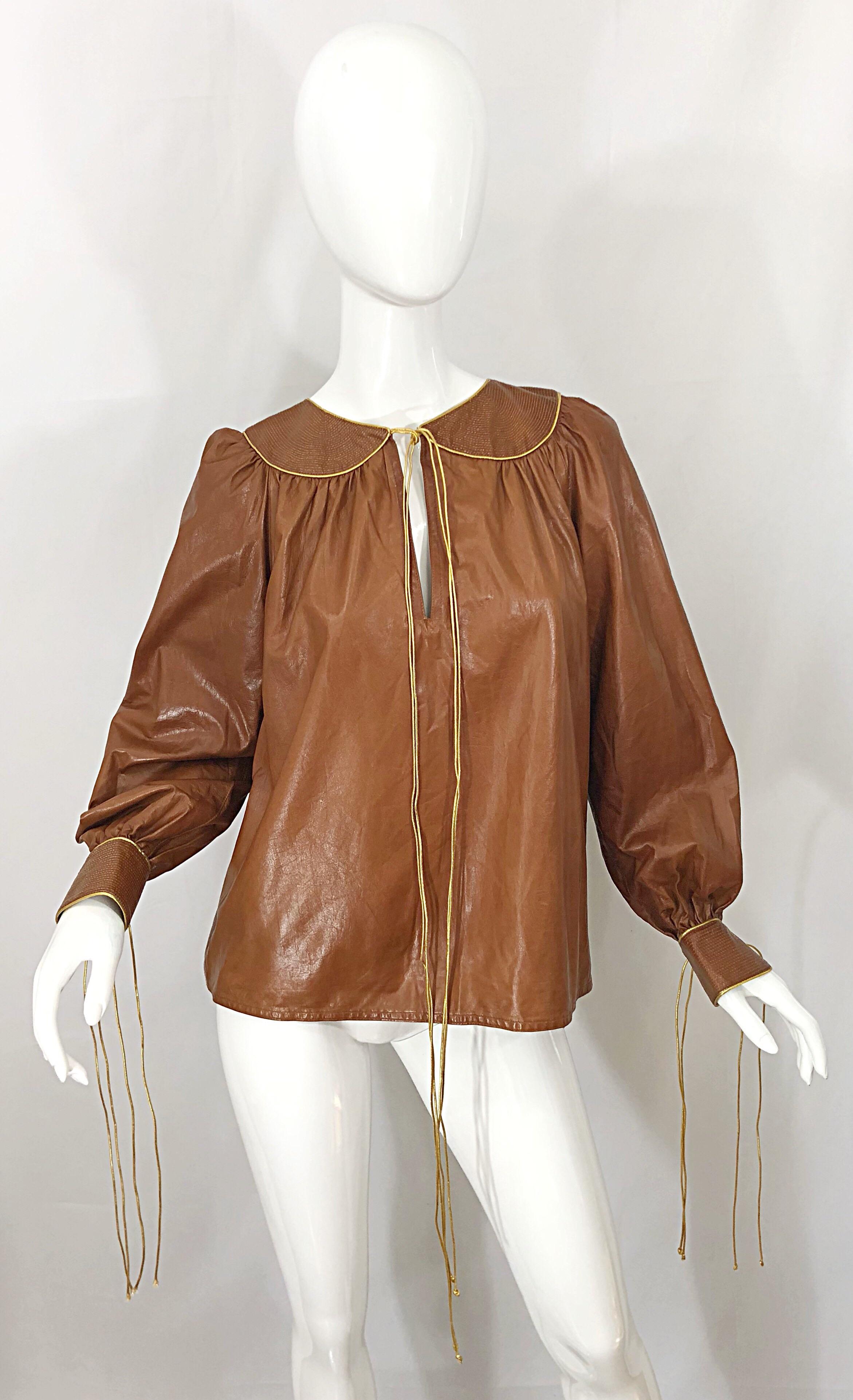 Rare, and nothing short of amazing 1970s GEOFFREY BEENE for NEIMAN MARCUS camel, tan / light brown butter soft leather shirt! Features a rich camel leather that will match anything and everything. Gold metallic cord ties at center neck and each